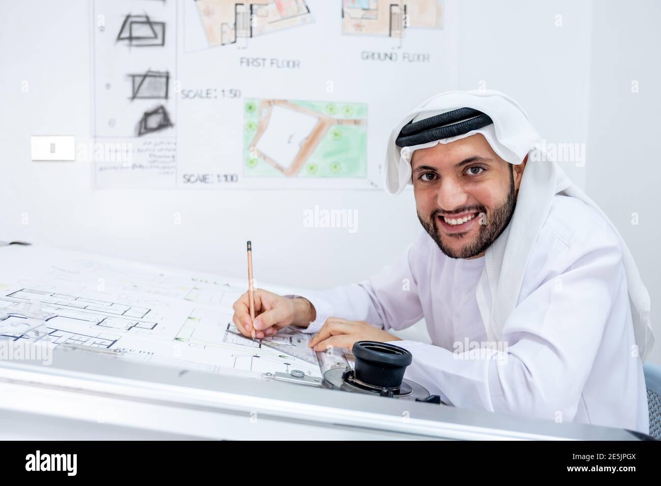 Arabic architecture working on his project and smiling Stock Photo