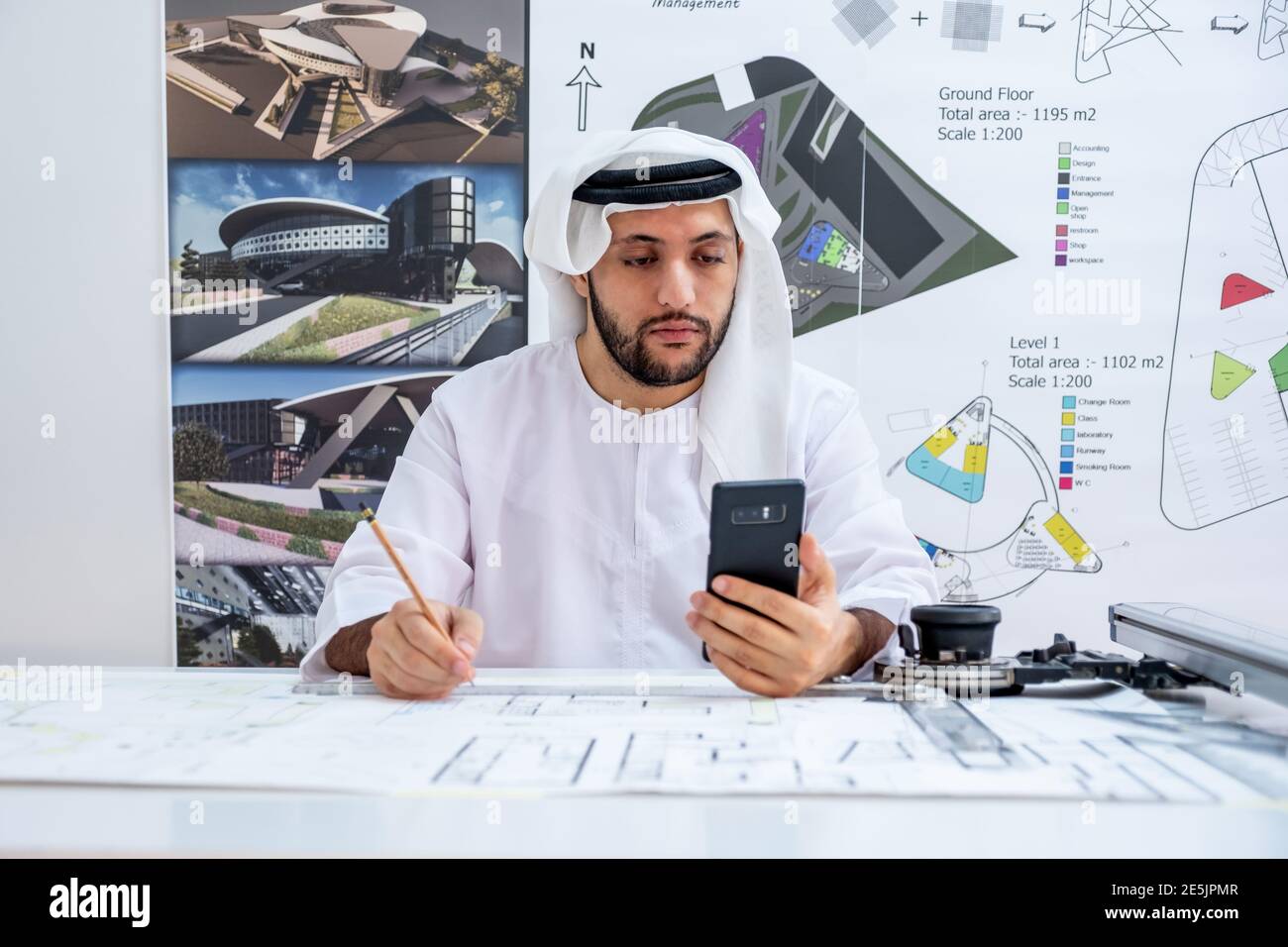 Arabic architecture enjoying online call while working on his project Stock Photo