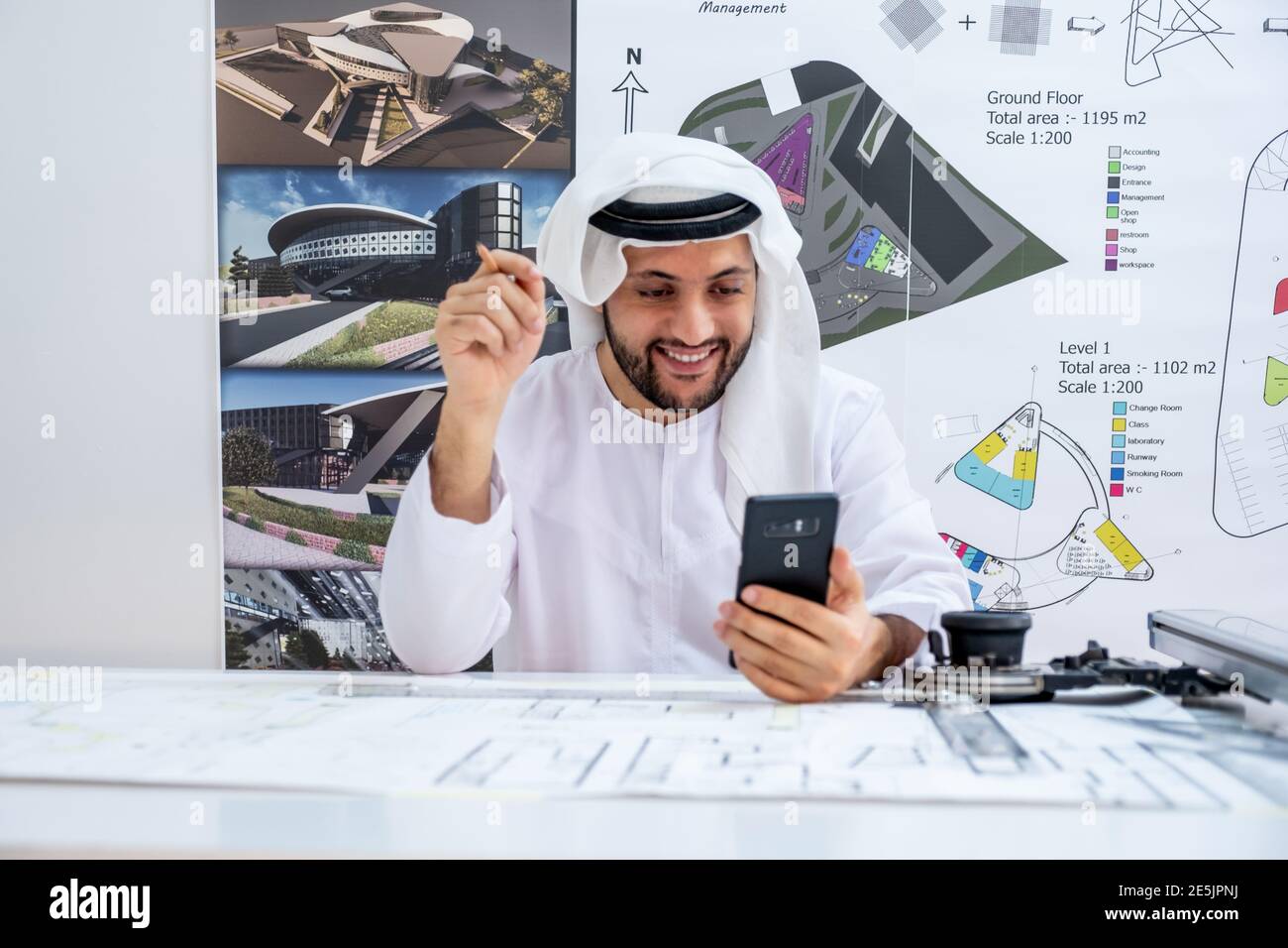 Arabic architecture enjoying online call while working on his project Stock Photo