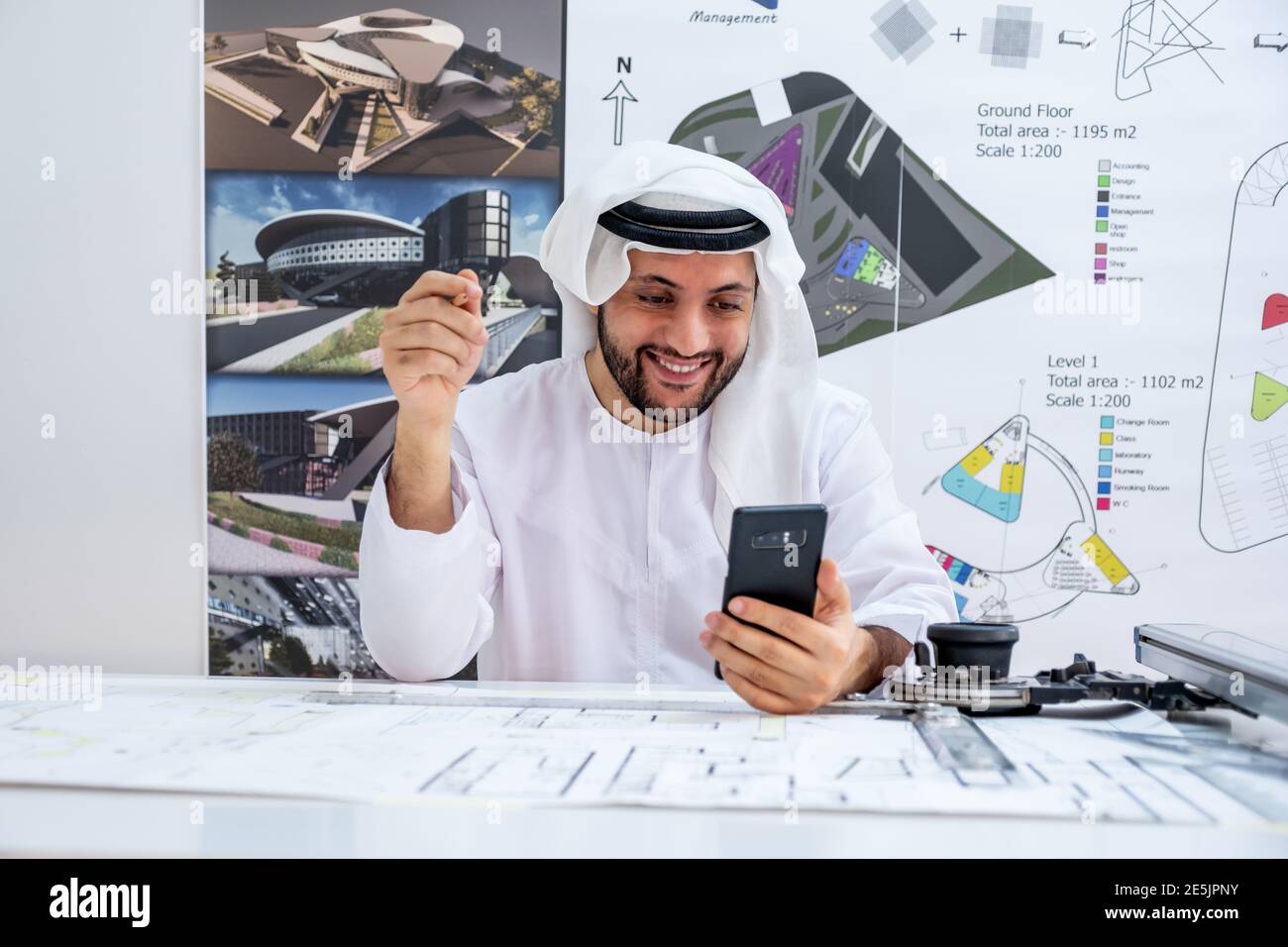 Arabic architecture enjoying online call while working on his project Stock Photo