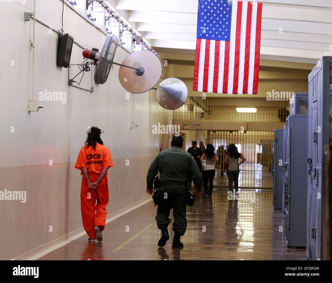 An inmate is led by a prison guard at the California Institution for Men state prison in Chino, California, June 3, 2011. The Supreme Court has ordered California to release more than 30,000 inmates over the next two years or take other steps to ease overcrowding in its prisons to prevent "needless suffering and death." California's 33 adult prisons were designed to hold about 80,000 inmates and now have about 145,000. The U.S. has more than 2 million people in state and local prisons. It has long had the highest incarceration rate in the world. REUTERS/Lucy Nicholson (UNITED STATES - Tags: CR Stock Photo