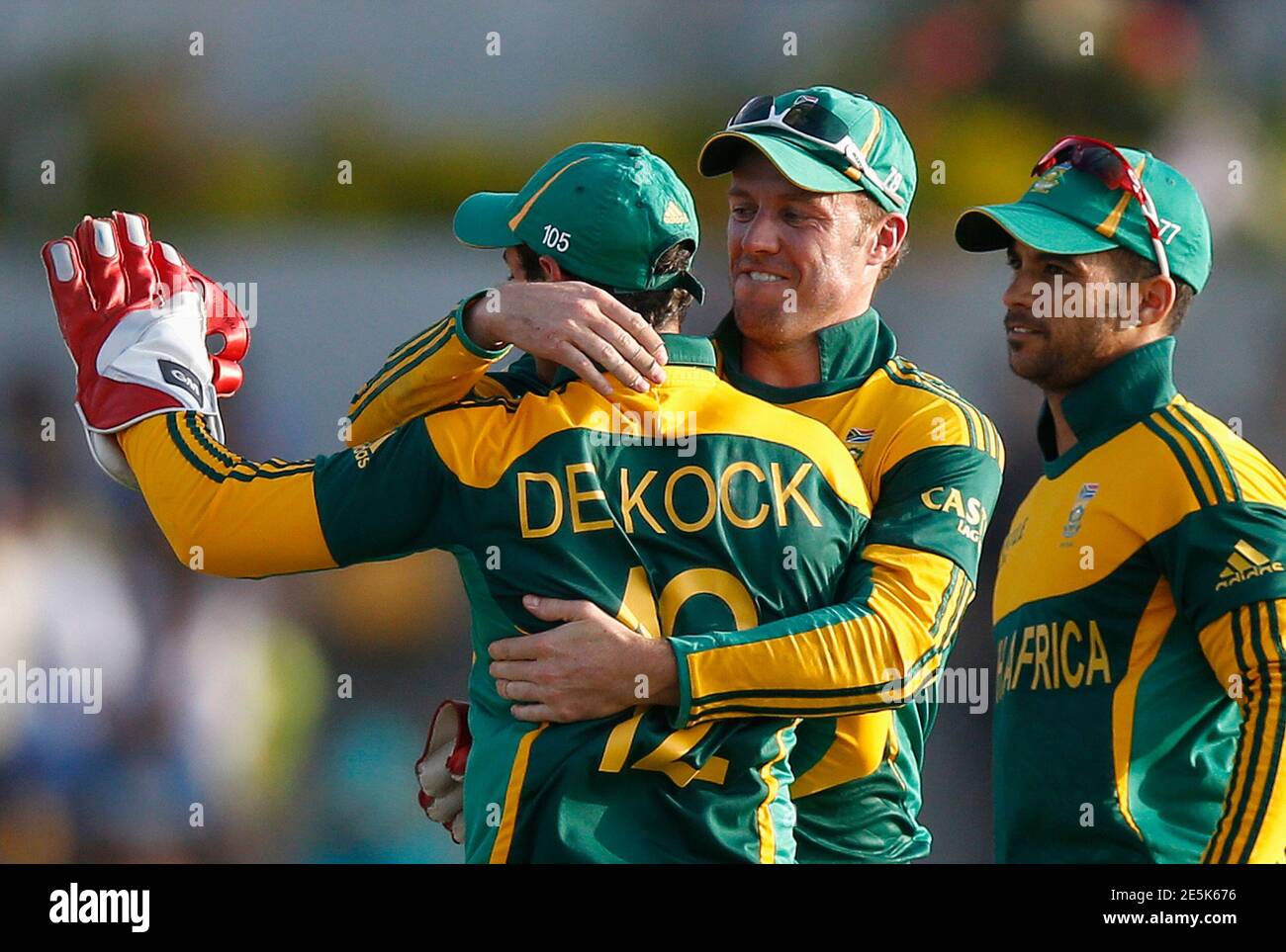 South Africa's captain AB de Villiers (C) celebrates dismissal of Sri Lanka's Ashan Priyanjan (not pictured) with teammates Quinton de Kock (12) and Jean-Paul Duminy (R) during their final One Day International cricket match in Hambantota July 12, 2014. REUTERS/Dinuka Liyanawatte (SRI LANKA - Tags: SPORT CRICKET) Stock Photo