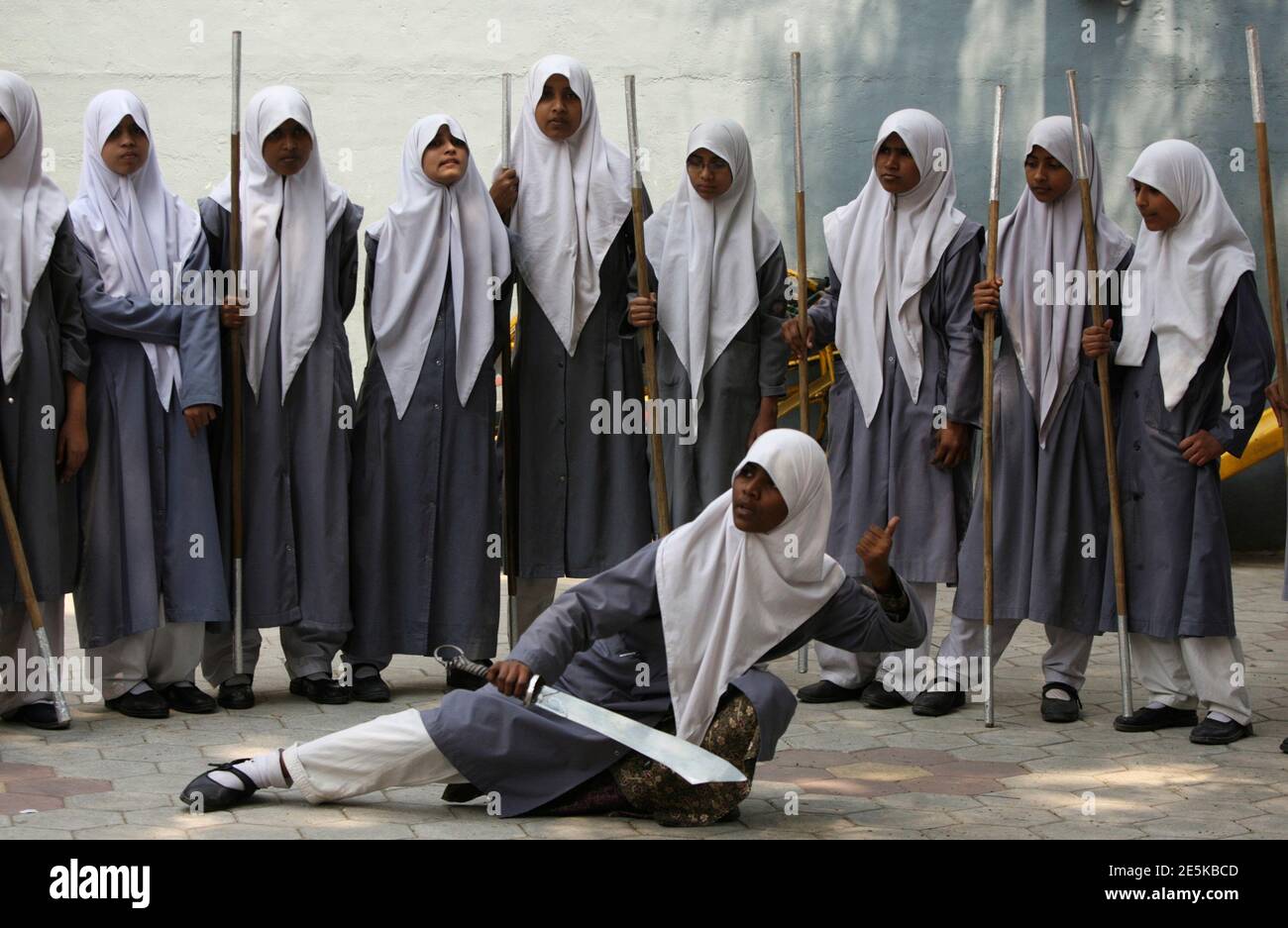 A Muslim schoolgirl from St. Maaz high school practises Vietnam Vovinam  martial arts inside the school compound on International Women's Day in the  southern Indian city of Hyderabad March 8, 2011. Girls
