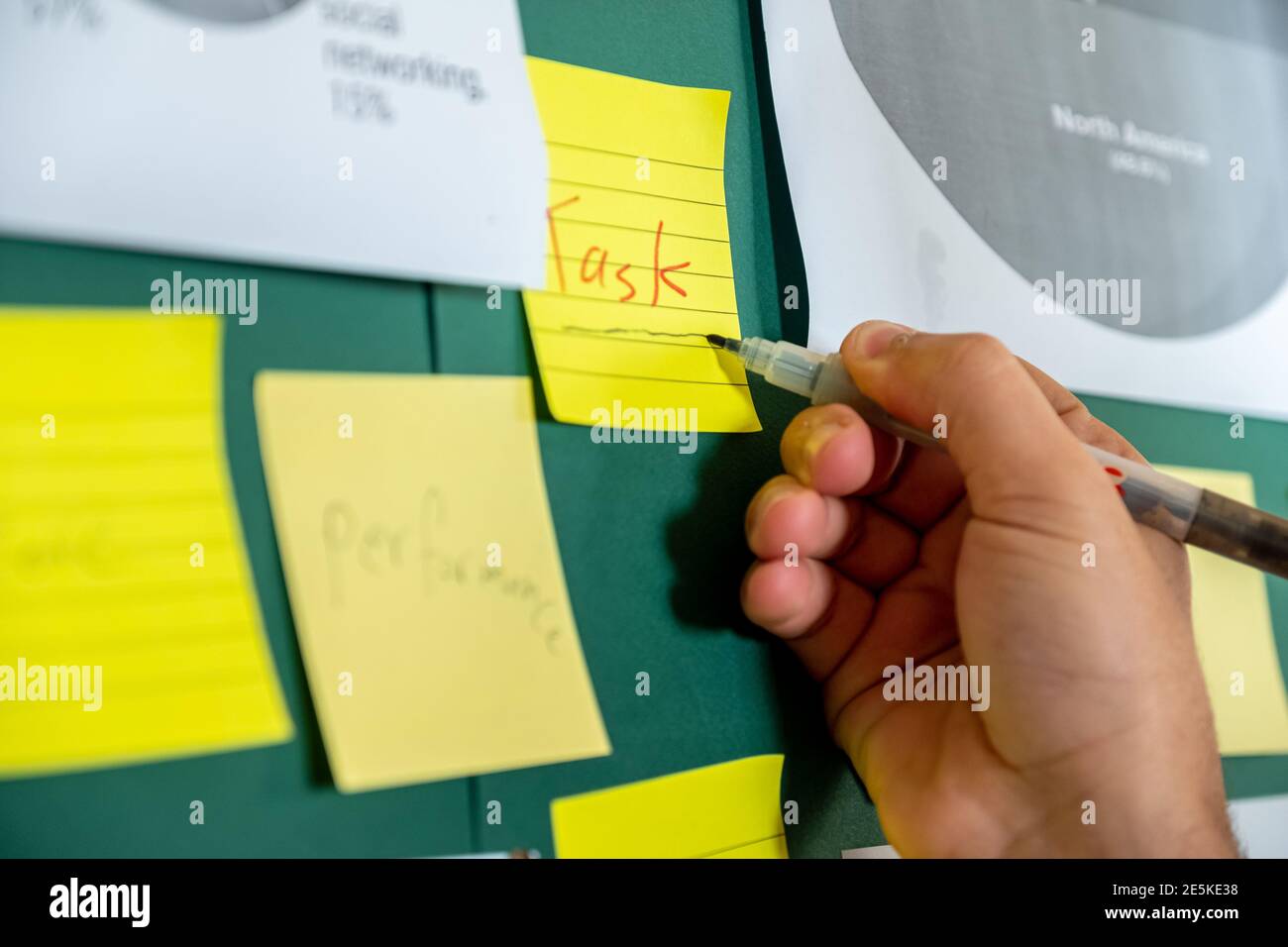 Businessman's hand writing tasks on notes Stock Photo