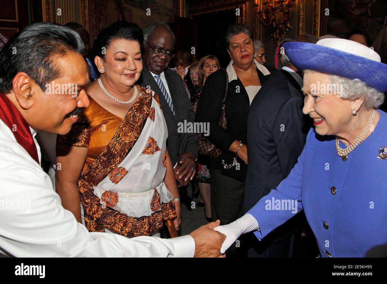 Britain's Queen Elizabeth (R) meets with Sri Lanka's President Mahinda Rajapaksa (L) and his wife Shiranthi Rajapaksa during a reception prior to a Diamond Jubilee lunch with Commonwealth Nations Heads of Government and representatives in central London June 6, 2012. REUTERS/Lefteris Pitarakis/POOL  (BRITAIN - Tags: ENTERTAINMENT ROYALS POLITICS) Stock Photo