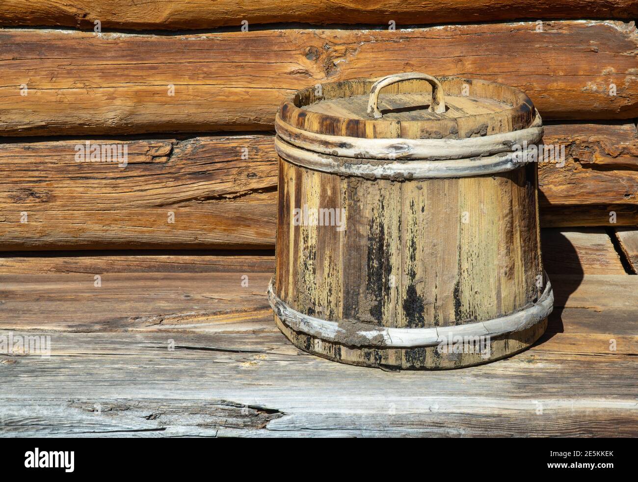 old wooden tub with lid. container made of wooden planks and covered