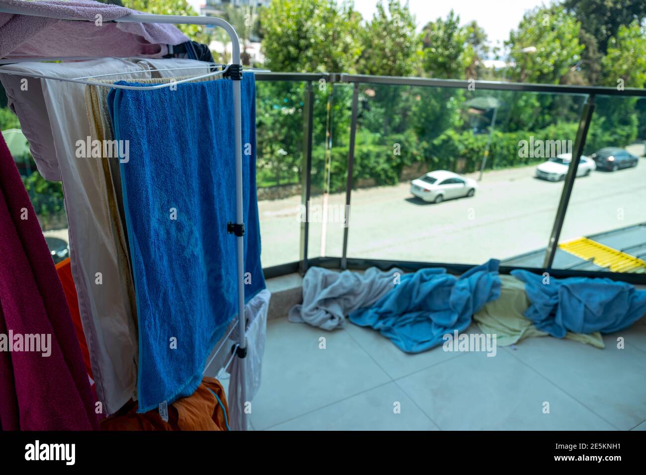 Doing the laundry in the morning and puting the towels on the rack Stock Photo