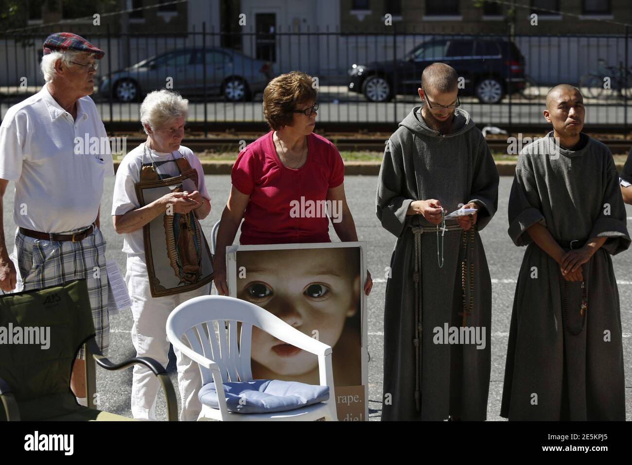Abortion protesters stand in front of a Planned Parenthood clinic in Boston, Massachusetts, June 28, 2014. Massachusetts is beefing up security around abortion clinics and scrambling for a legal fix after the U.S. Supreme Court voided the state's buffer zone law that kept protesters 35 feet away, saying it violated freedom of speech. REUTERS/Dominick Reuter  (UNITED STATES - Tags: CRIME LAW POLITICS HEALTH RELIGION) Stock Photo