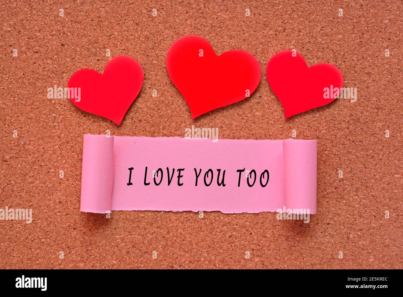 I love you too label on Torn paper with heart shape on wooden ...