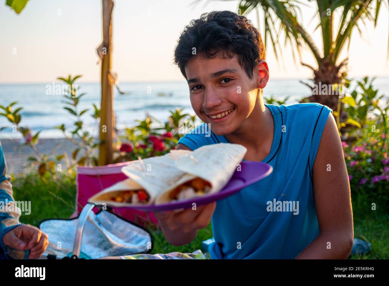 Yong boy is showing his favourite sandwich Stock Photo