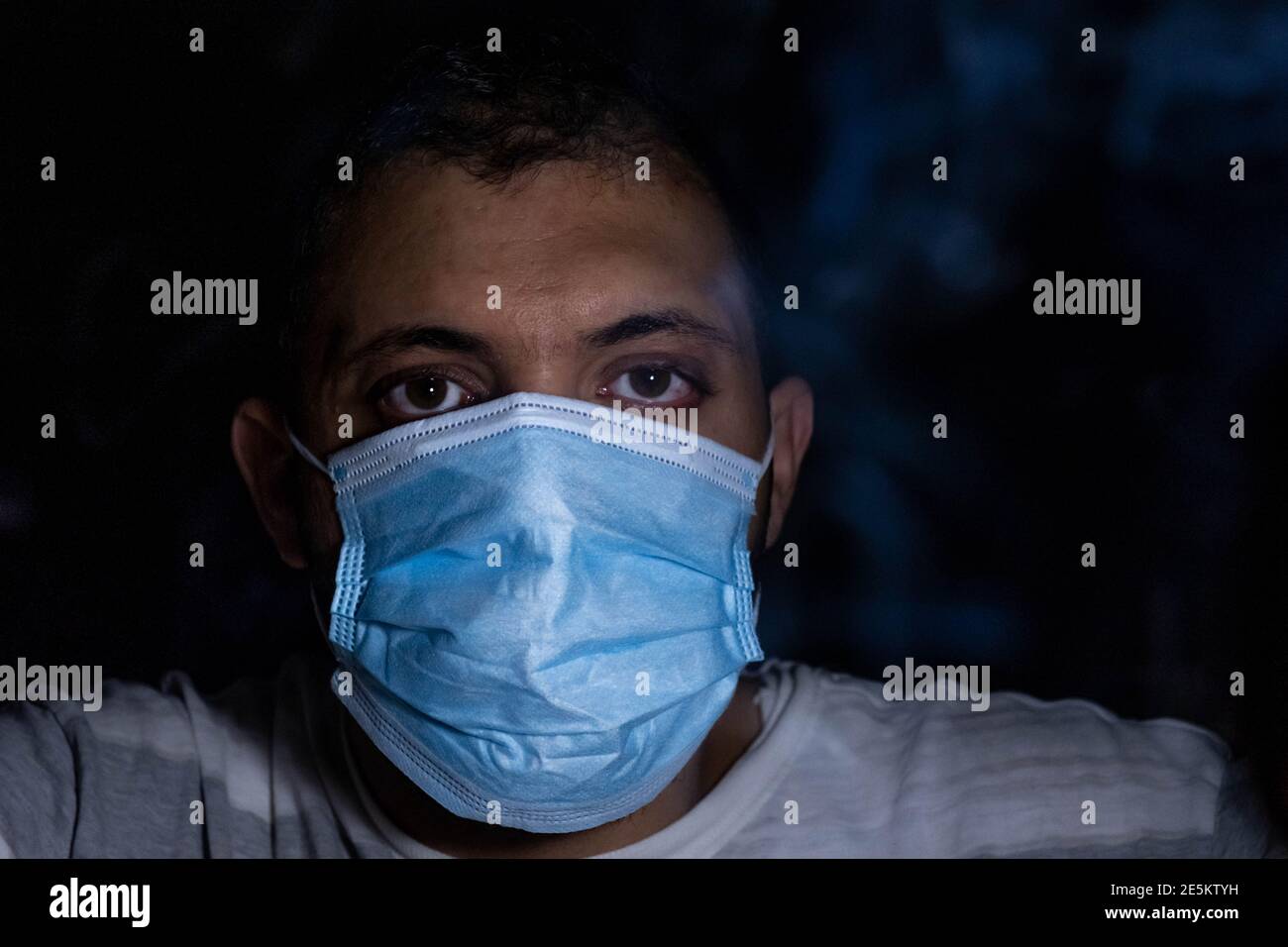 Man in the dark wearing protection mask to protect his breath from ...