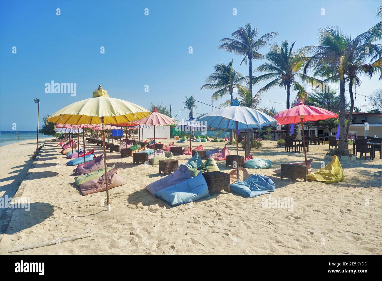 LOMBOK, INDONESIA - OCT 23, 2020: Bean bags and Parasols for beach visitors and guests in front of Aston Sunset Beach Resort, Gili Trawangan, Lombok Stock Photo