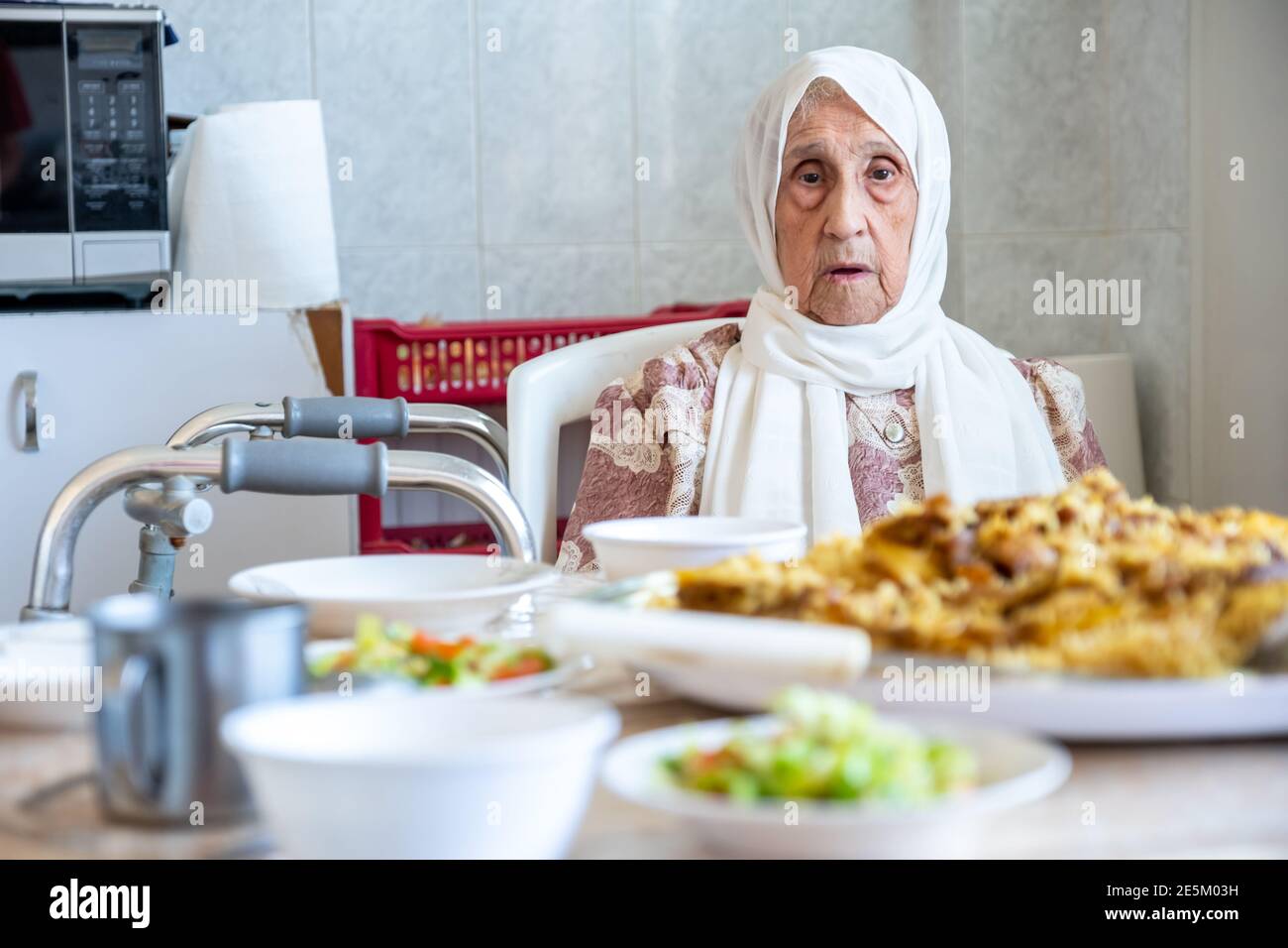 Old woman is using walker Stock Photo