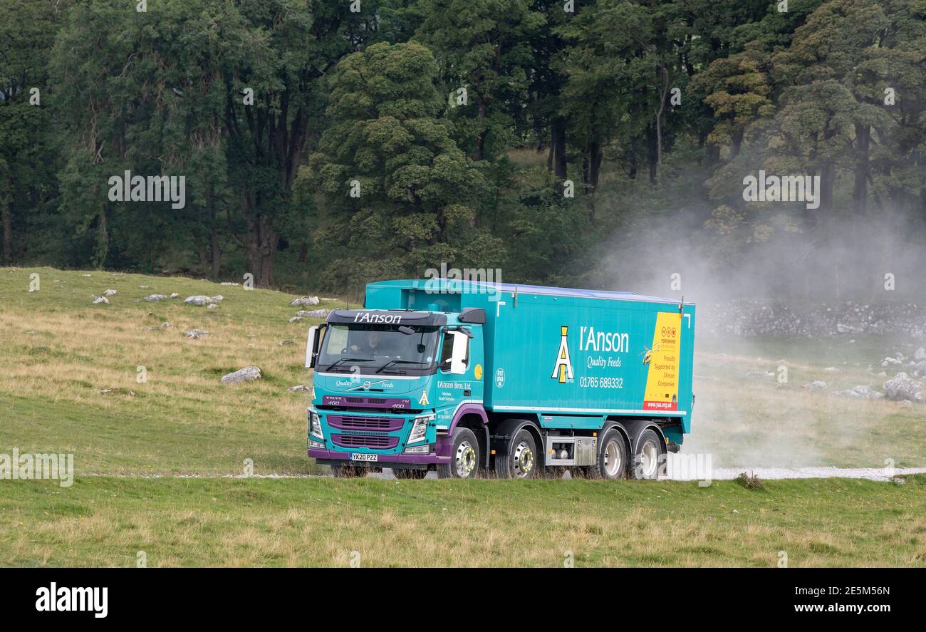 I'Anson livestock feed wagon travelling down a farm track in the