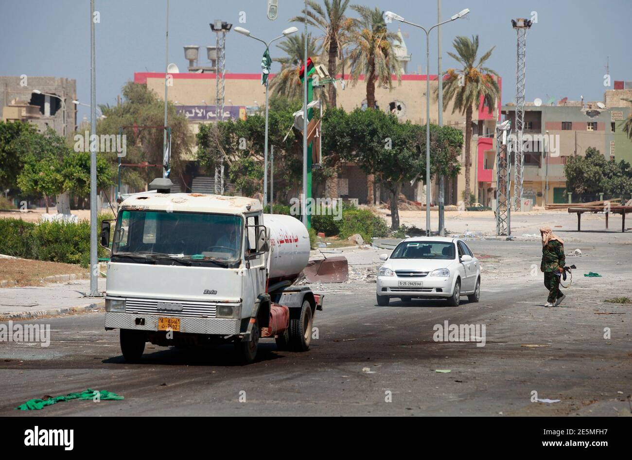 A Libyan rebel fighter directs traffic in the main square after rebels sized control of the center of the strategic coastal city of Zawiyah, August 20, 2011.   REUTERS/Bob Strong  (LIBYA - Tags: CIVIL UNREST POLITICS) Stock Photo