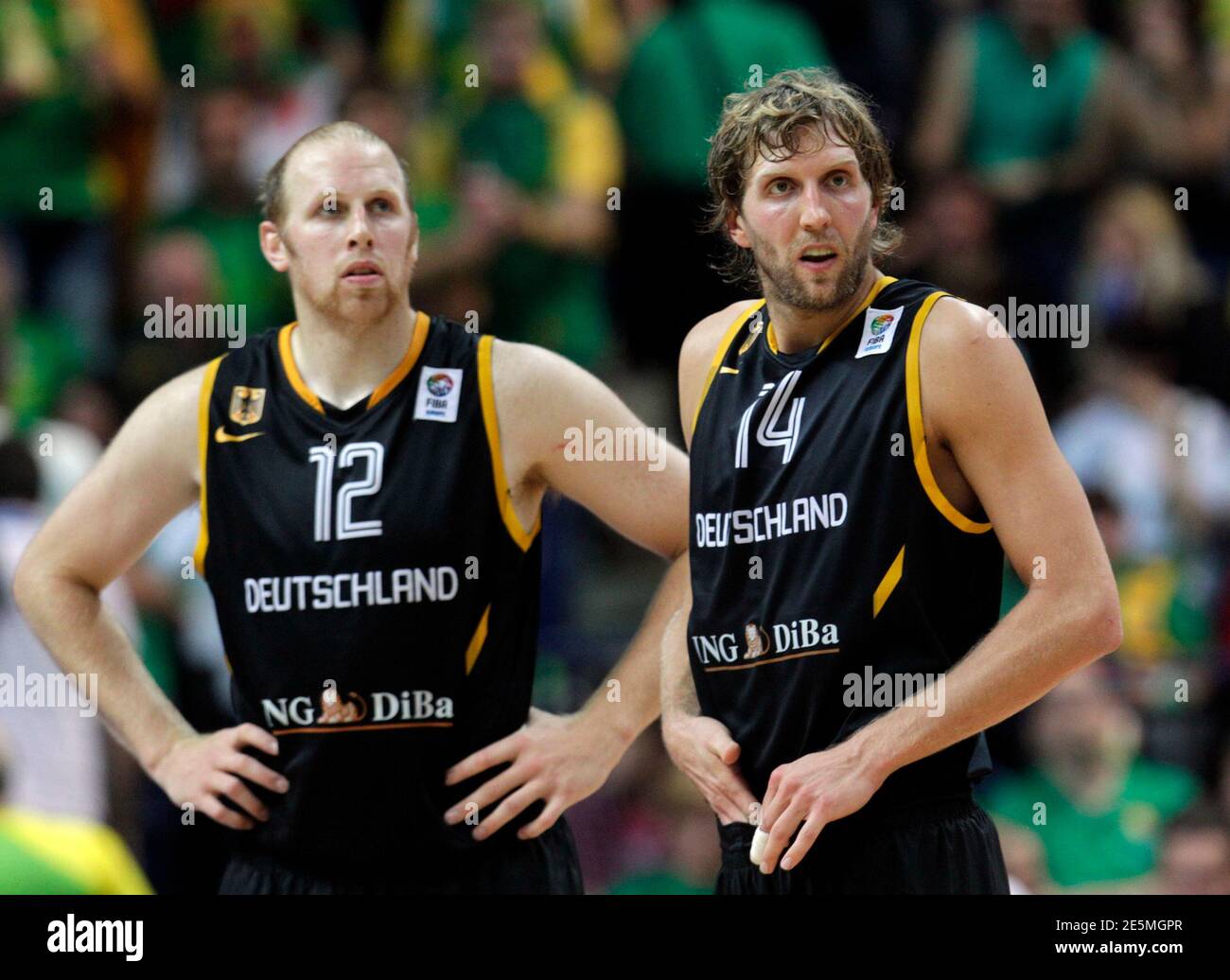 Germany's Dirk Nowitzki (R) and teammate Chris Kaman wait to start the  second half against Lithuania during their FIBA EuroBasket 2011 Group E  basketball game in Vilnius September 11, 2011. REUTERS/Ints Kalnins (