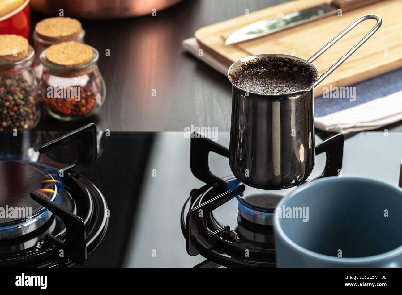 https://c8.alamy.com/comp/2E5MH0E/brew-coffee-in-a-steel-turk-on-a-gas-stove-2E5MH0E.jpg