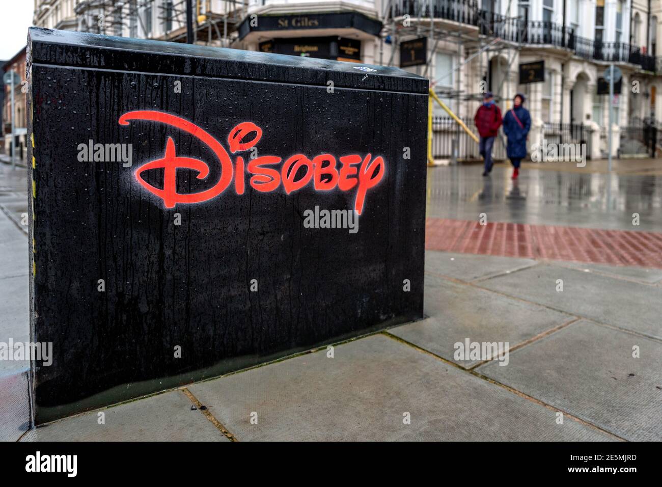Brighton, January 19th 2021: Street art in Brighton using the famous Disney logo to spell the word 'disobey' Stock Photo