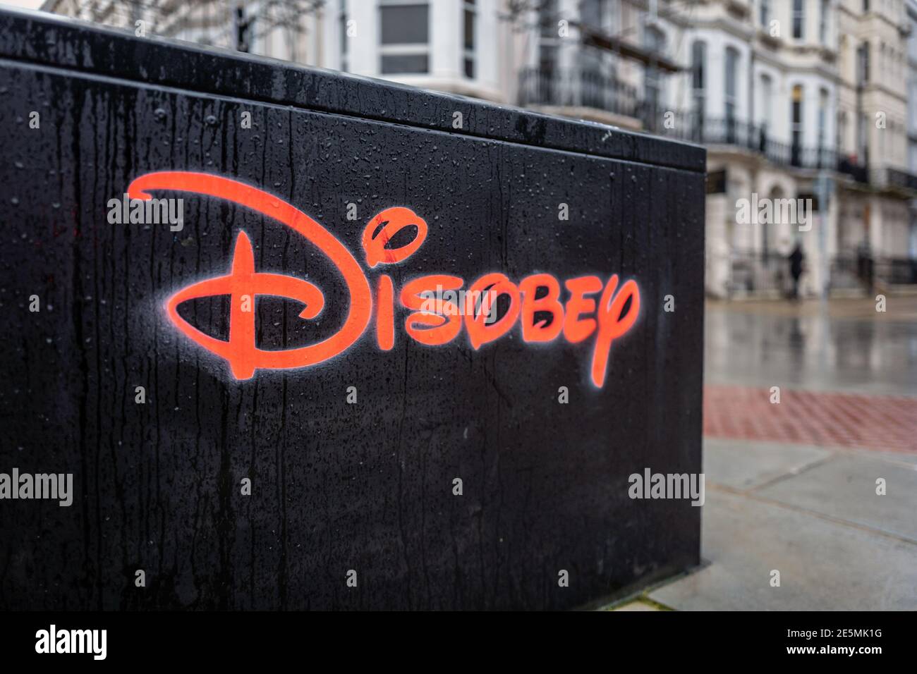Brighton, January 19th 2021: Street art in Brighton using the famous Disney logo to spell the word 'disobey' Stock Photo