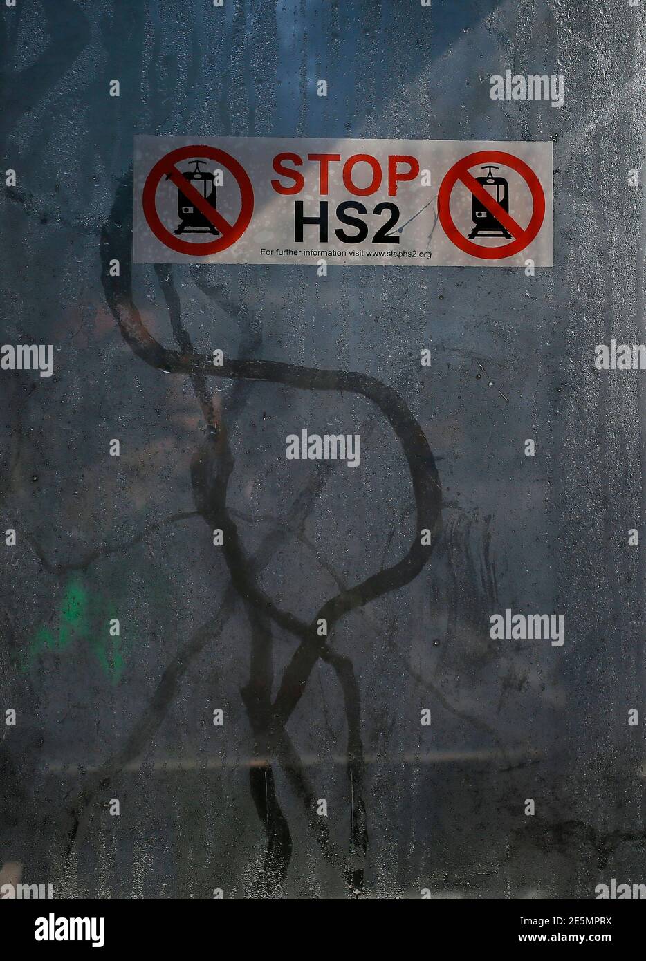 Condensation trails run beneath an anti high speed rail project (HS2) sticker in the window of a telephone box near the village of Pickmere, northern England September 9, 2013. Britain's transport secretary said the UK's planned HS2 high-speed rail network was 'essential' to the country after a group of MPs criticised the project.  REUTERS/Phil Noble (BRITAIN - Tags: BUSINESS POLITICS TRANSPORT) Stock Photo