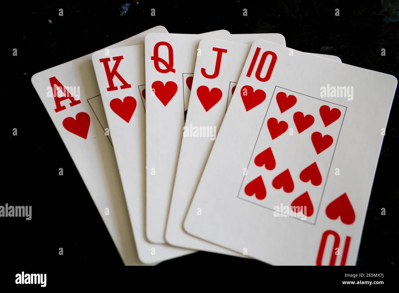 Create an artistic representation of a royal flush, the highest-ranking  hand in poker, using vibrant colors and intricate details. showcase the  five cards (ace, king, queen, jack, and ten) from a single