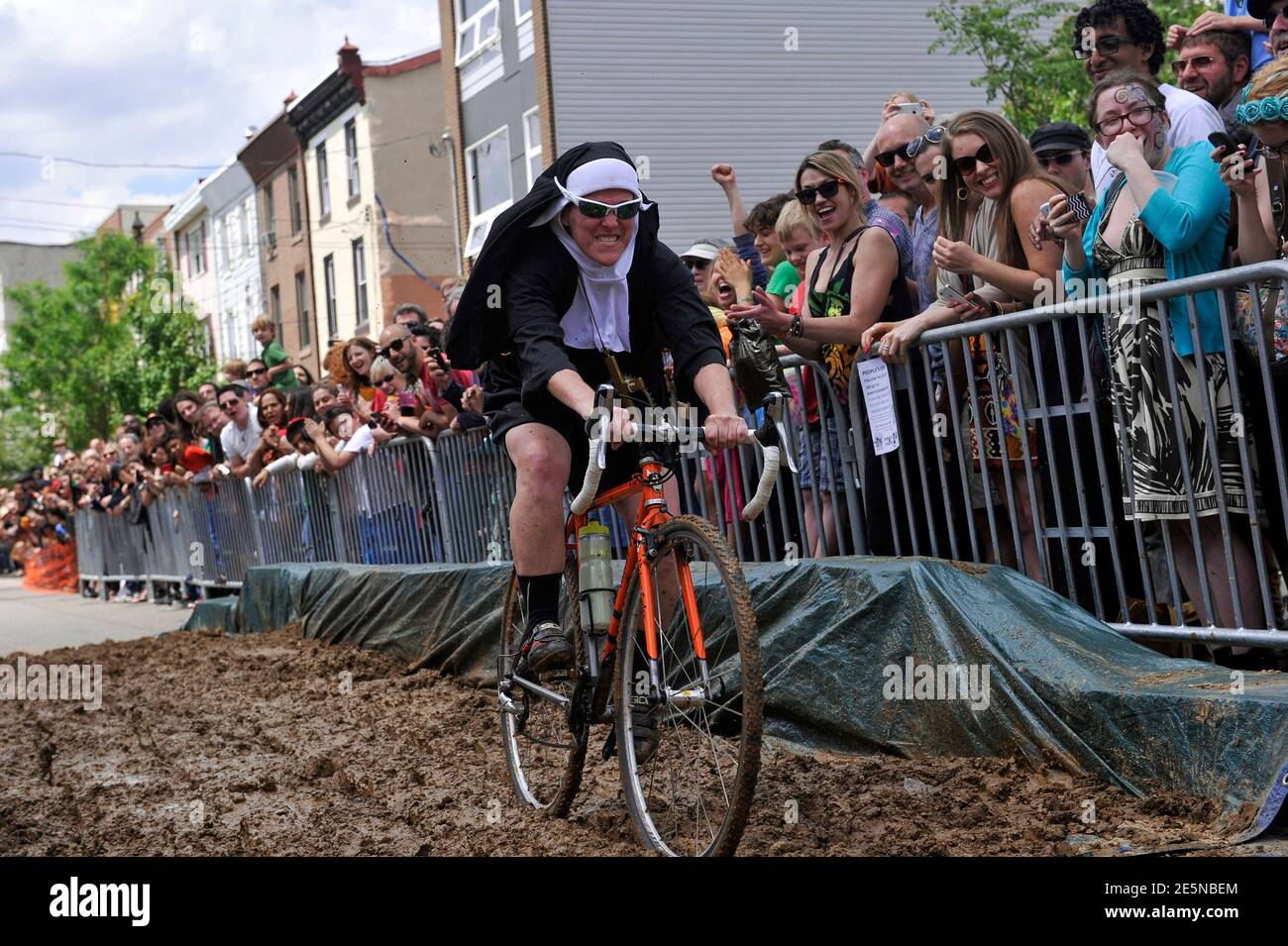A man wearing a nun's habit cycles through the streets of ...