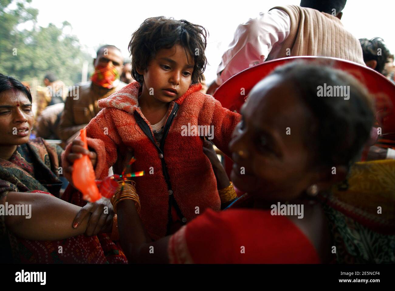 A girl is united with her mother at the lost and found camp after getting lost in the crowd during the 'Gadhimai Mela' festival held in Bariyapur November 29, 2014. Sword-wielding Hindu devotees in Nepal began slaughtering thousands of animals and birds in a ritual sacrifice on Friday, ignoring calls by animal rights activists to halt what they described as the world's largest such exercise. REUTERS/Navesh Chitrakar (NEPAL - Tags: RELIGION SOCIETY) Stock Photo