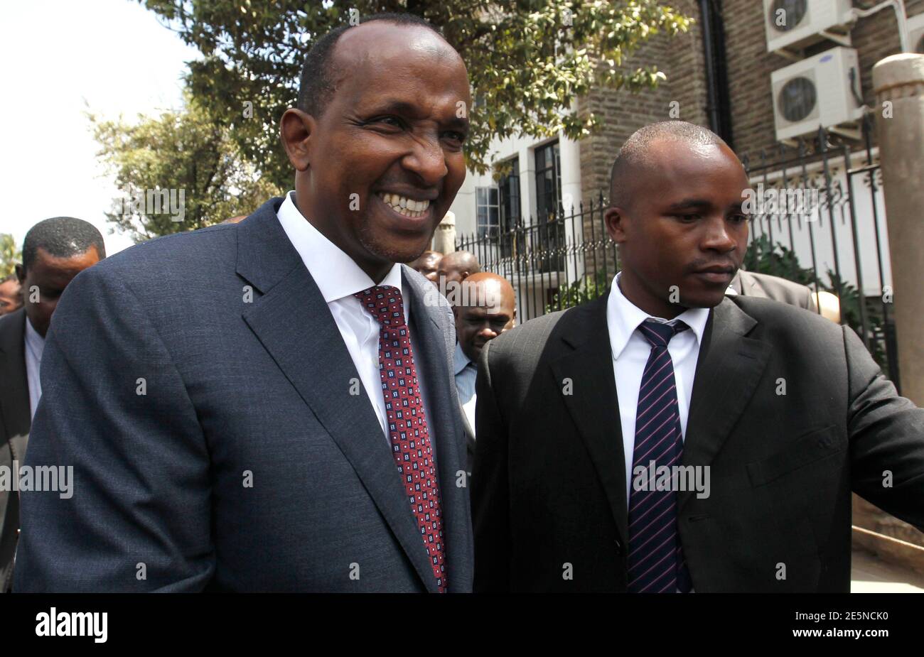 Kenya's National Assembly majority leader Aden Duale (L) is escorted as he walks out of Parliament in Kenya's capital Nairobi, December 18, 2014. Kenya's parliament approved new anti-terrorism laws on Thursday in the face of vocal protests by some opposition lawmakers who said the measures threatened civil liberties and free speech, legislators said. REUTERS/Thomas Mukoya (KENYA - Tags: POLITICS CIVIL UNREST) Stock Photo