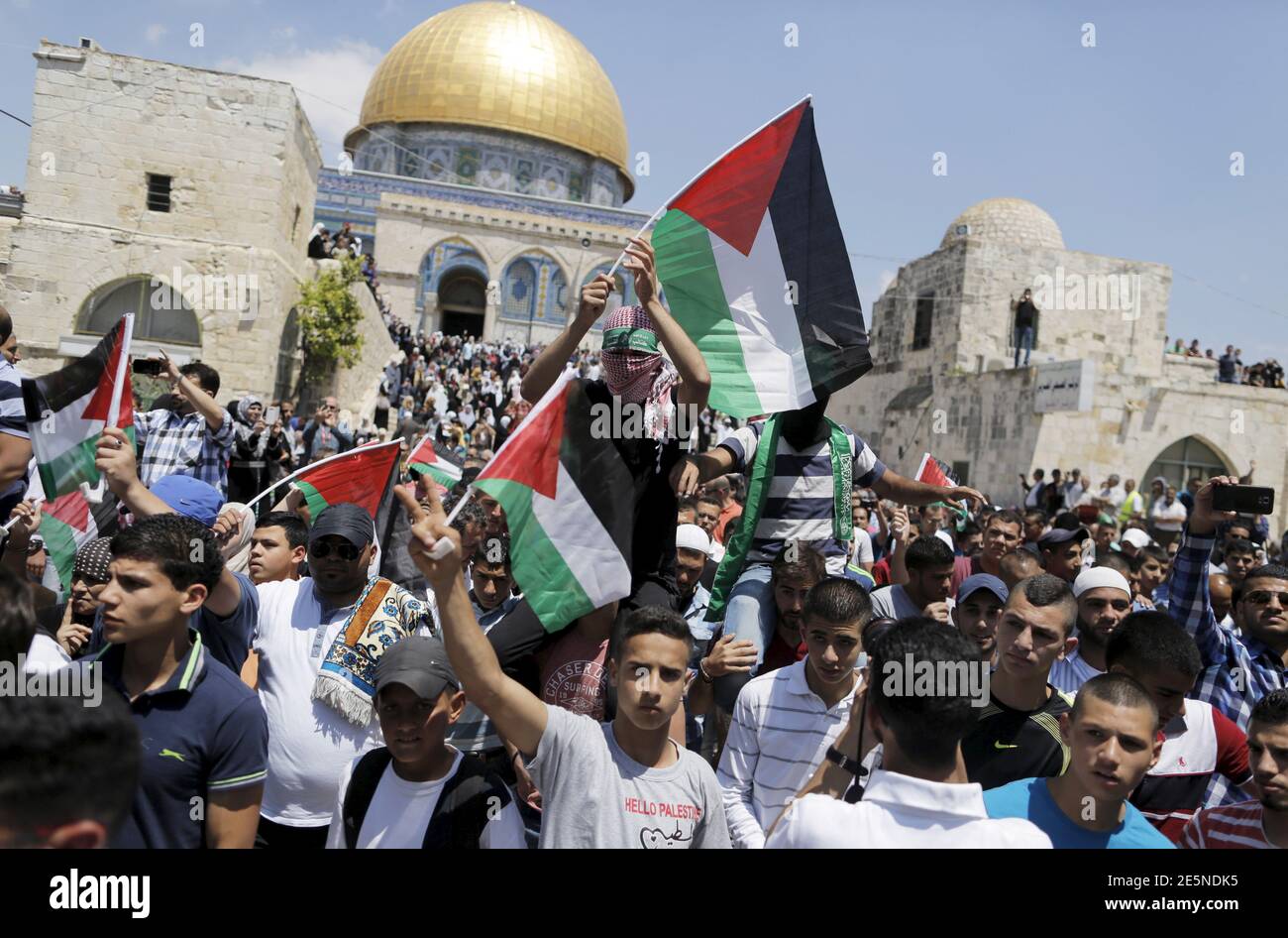 Palestinians wave flags after Friday prayers during a protest to mark Nakba day near the Dome of the Rock on the compound known to Muslims as Noble Sanctuary and to Jews as Temple Mount, in Jerusalem's Old City May 15, 2015. Palestinians mark 'Nakba' (Catastrophe) on May 15 to commemorate the expulsion or fleeing of some 700,000 Palestinians from their homes in the war that led to the founding of Israel in 1948. REUTERS/Ammar Awad Stock Photo