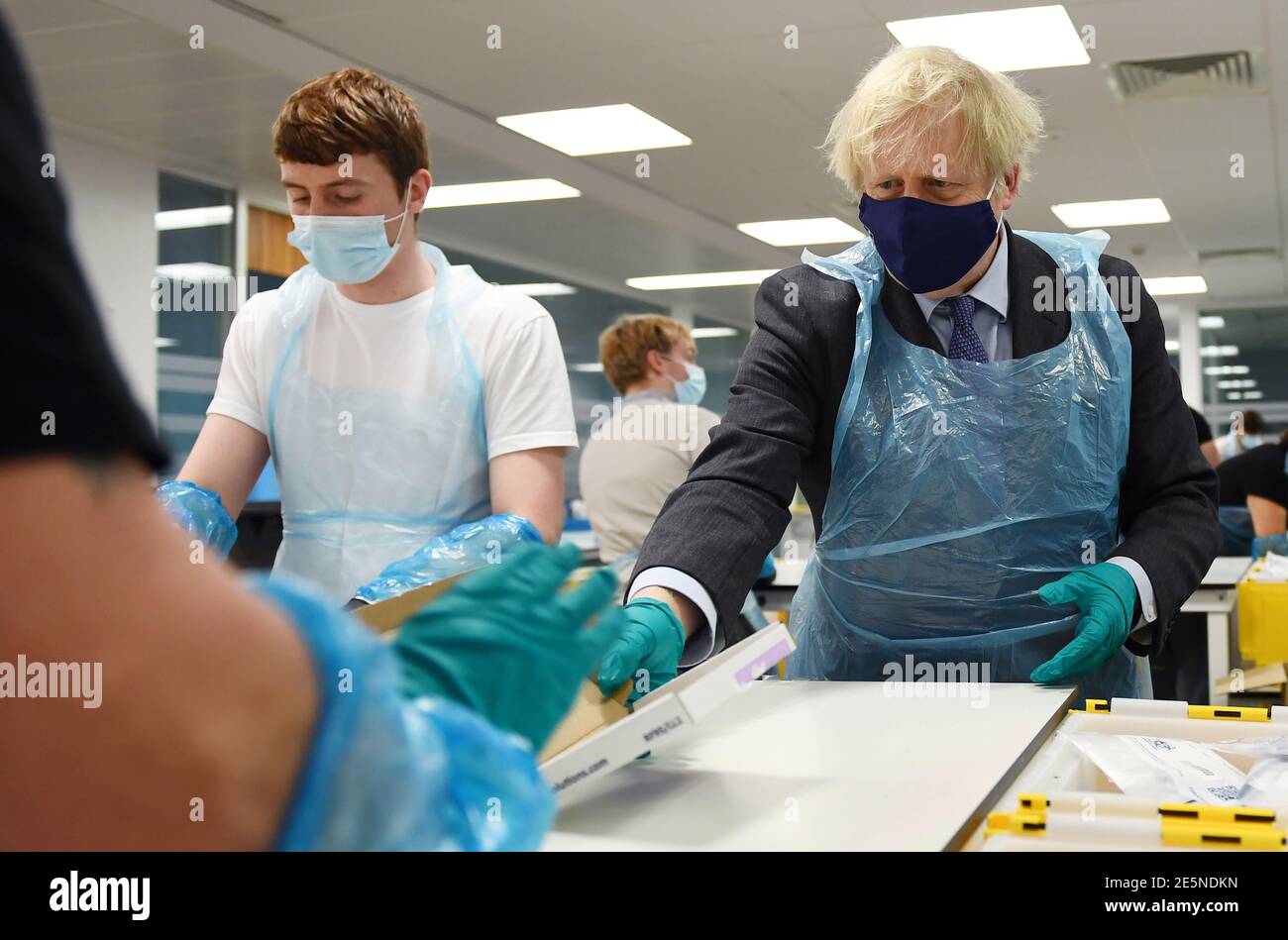 Prime Minister Boris Johnson (right) is shown the Lighthouse Laboratory ...