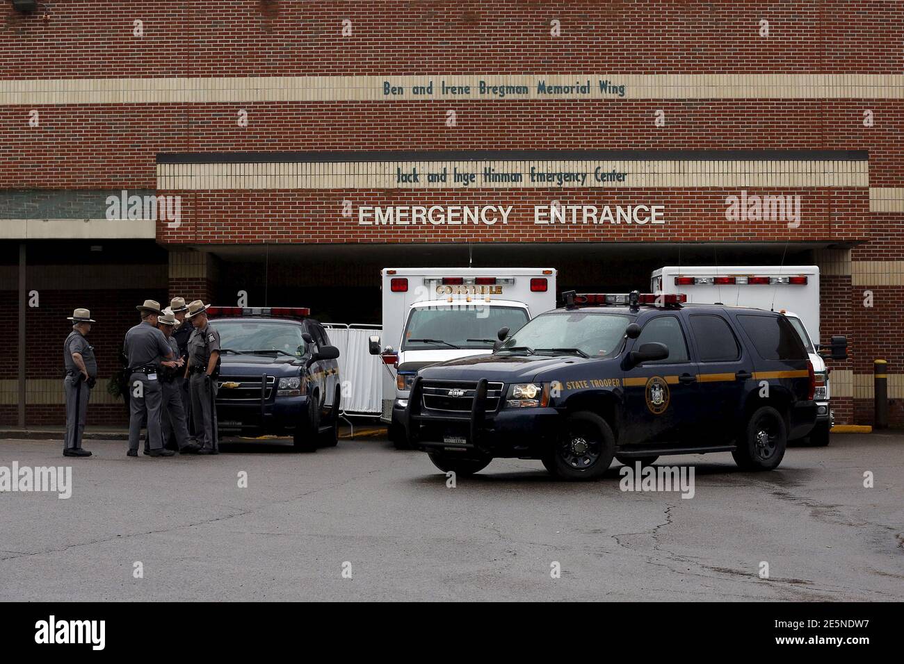 Law enforcement officers gather outside the Alice Hyde Medical Center in Malone, New York June 28, 2015. David Sweat, one of two New York state inmates who escaped from prison three weeks ago, was shot by police near the Canadian border and rushed to a local hospital on Sunday, two days after his accomplice was killed, authorities said. REUTERS/Chris Wattie Stock Photo
