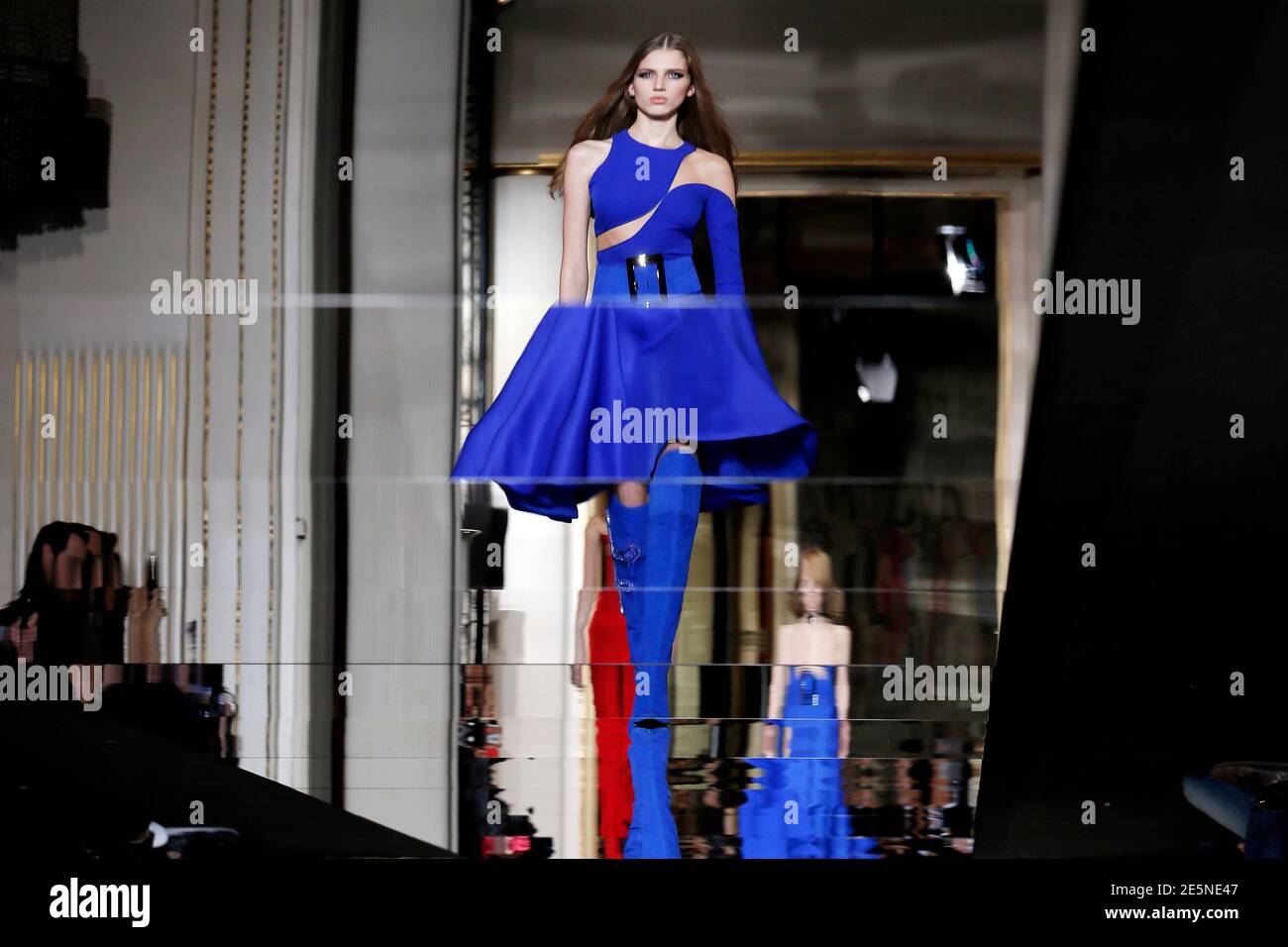 A model is reflected in the runway as she presents a creation by Italian  designer Donatella Versace as part of her Haute Couture Spring Summer 2015  fashion show in Paris January 25,