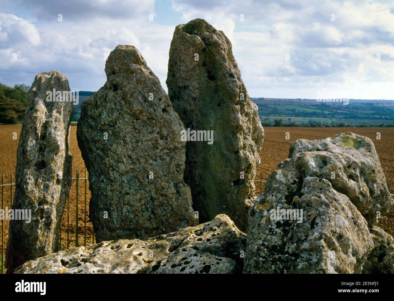 View SE of the Whispering Knights portal dolmen, Oxfordshire, UK: 5 limestone slabs, remains of a Neolithic burial chamber, fallen capstone bottom L. Stock Photo