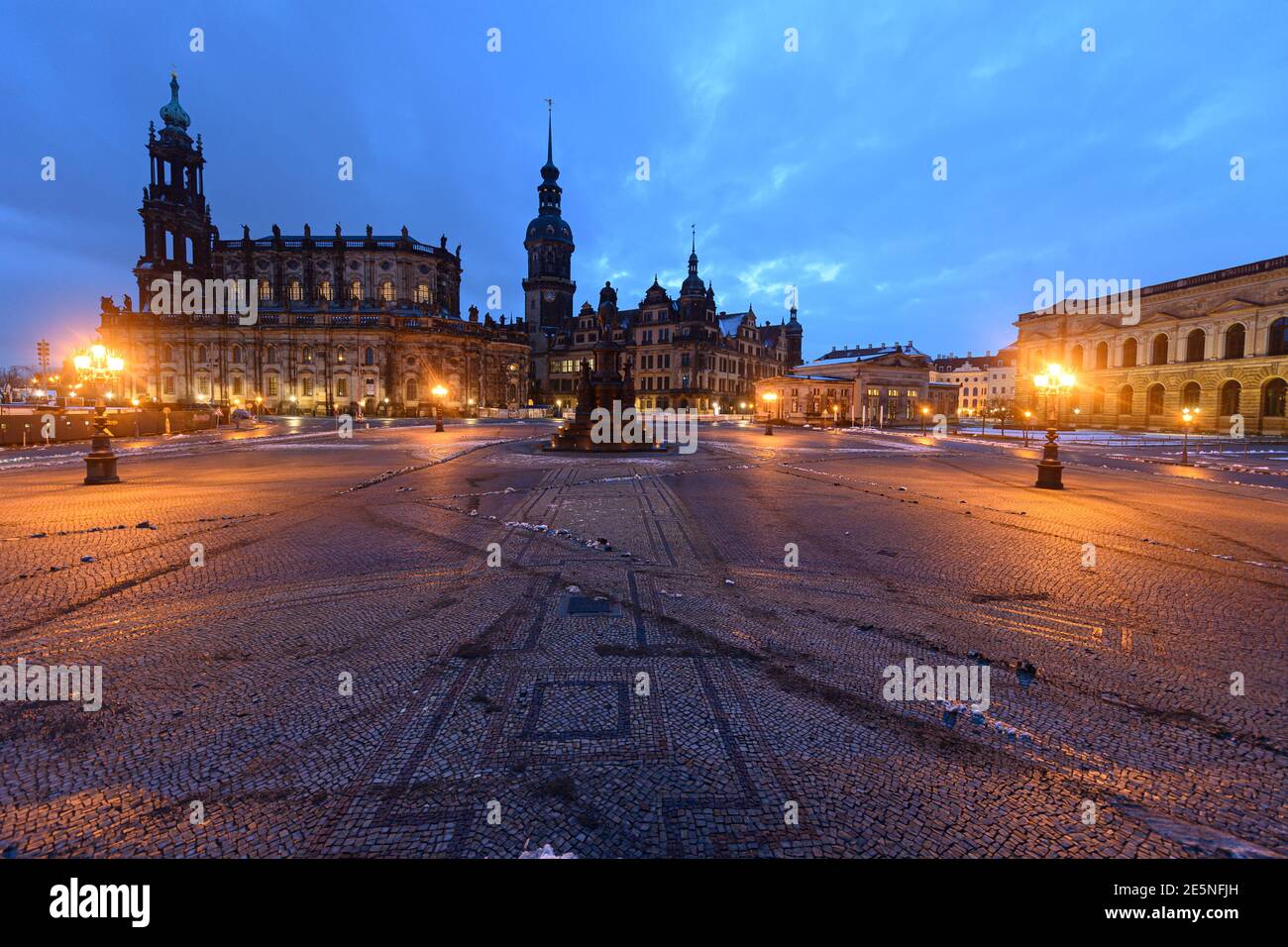 Dresden, Germany. 25th Jan, 2021. Remnants of snow lie in the morning on the Theaterplatz in front of the Hofkirche (l-r), the Hausmannsturm, the equestrian statue of King Johann, the Residenzschloss, the Schinkelwache and the Zwinger. Credit: Robert Michael/dpa-Zentralbild/dpa/Alamy Live News Stock Photo