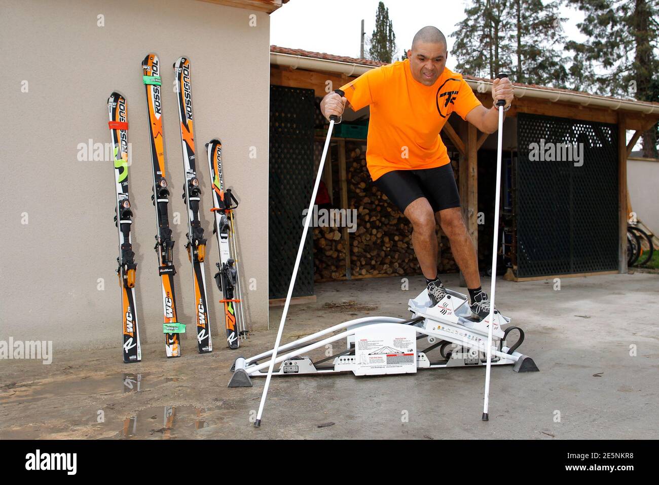 Jean-Pierre Roy, an IT specialist and President and only member of the  Haitian Ski Federation, demonstrates a training session for Reuters in his  garden in Orgerus, near Paris, February 4, 2011. Roy,