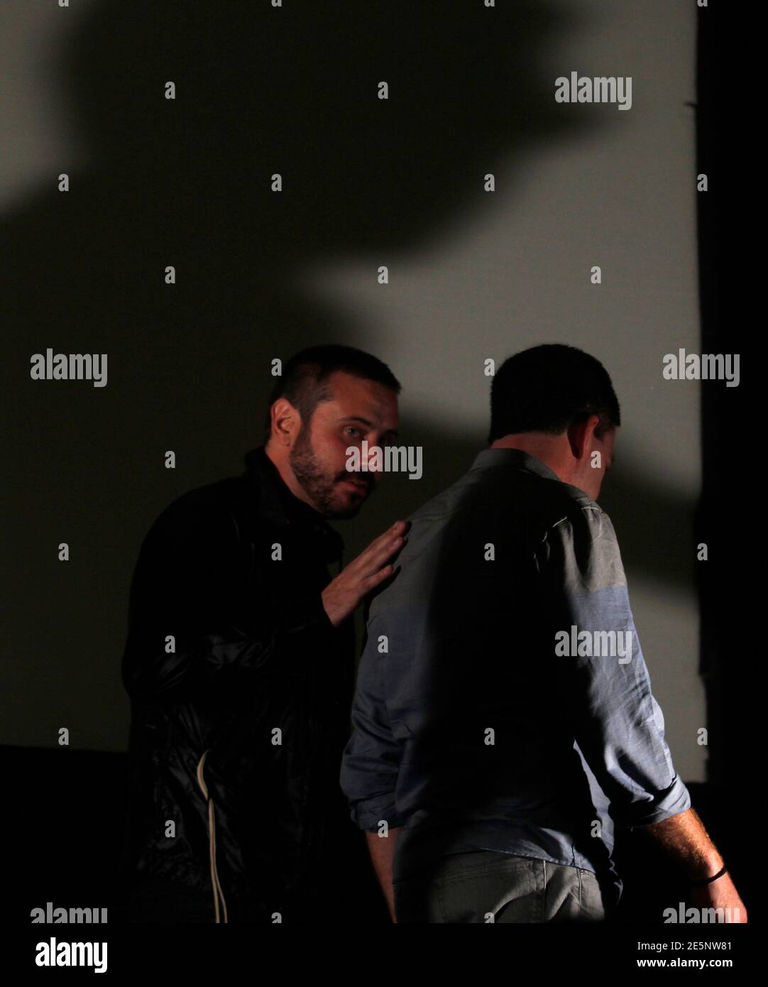 U.S. journalists Jeremy Scahill (L) and Glenn Greenwald leave the room after the presentation of the documentary film 'Dirty Wars' during the Rio Film Festival in Rio de Janeiro September 28, 2013. REUTERS/Pilar Olivares (BRAZIL - Tags: ENTERTAINMENT) Stock Photo