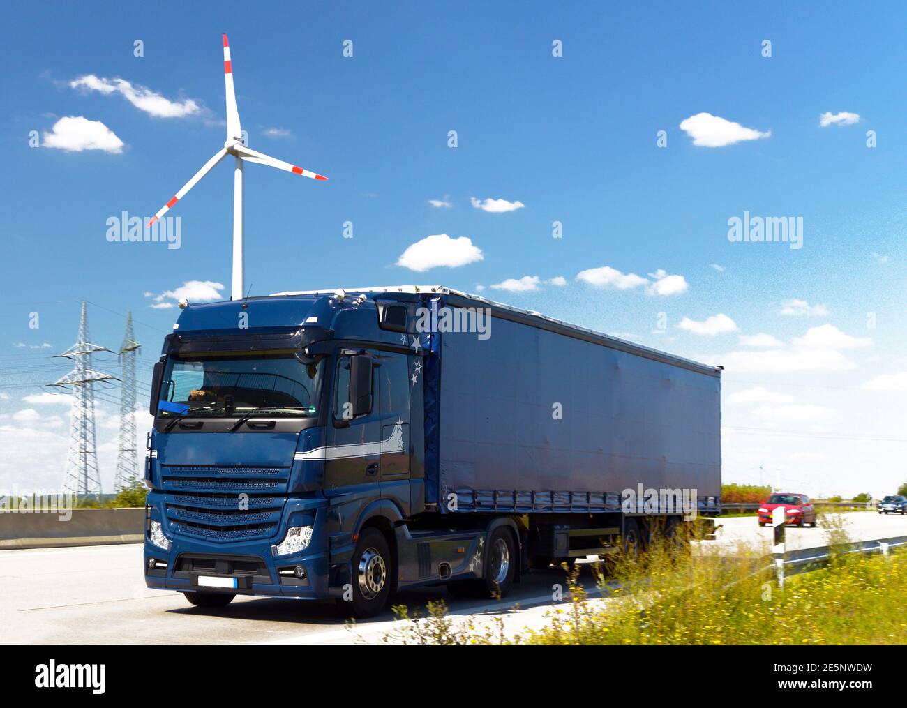 road transport of goods by truck - trade and logistics - in the backgrounds windmills Stock Photo