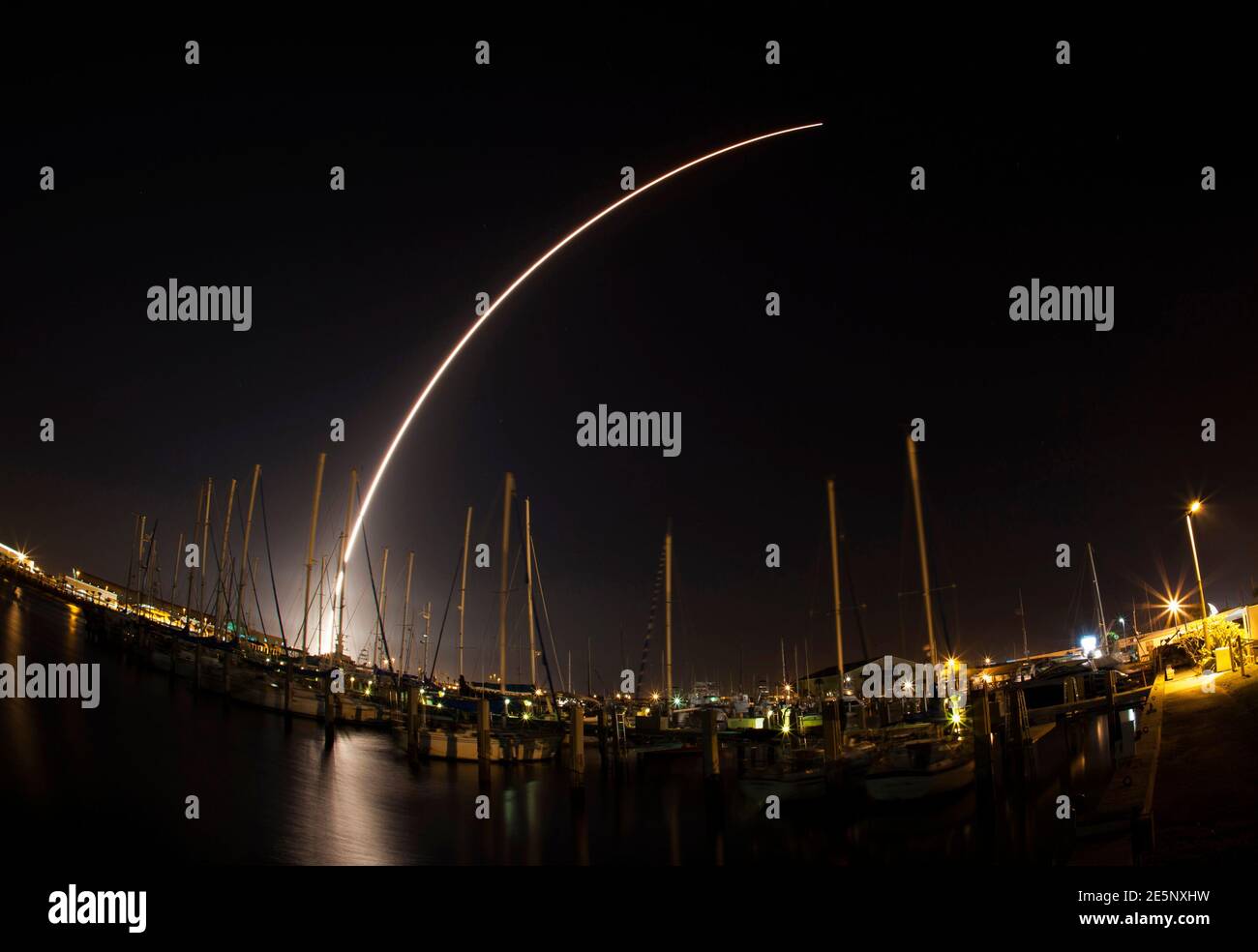 The Delta IV rocket is seen streaking across the sky after being launched from Cape Canaveral Air Force Station as pictured from Port Canaveral, Florida February 20, 2014. The U.S. Global Positioning System satellite was launched into orbit on Thursday, buttressing a 31-member navigation network in constant use by the military, civilian agencies and commercial customers worldwide. The satellite, built by Boeing, was carried into space aboard an unmanned Delta IV rocket, which blasted off from Cape Canaveral Air Force Station in Florida at 8:59 p.m. EST/0159 Friday GMT. Picture taken with long  Stock Photo