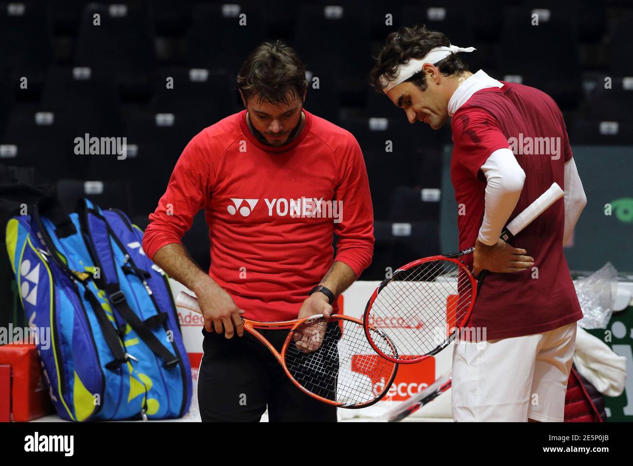 Roger Federer (R) and Stanislas Wawrinka of Switzerland attend a Davis Cup  tennis training session at the Pierre Mauroy stadium in Villeneuve d'Ascq,  northern France, November 20, 2014. France will face Switzerland