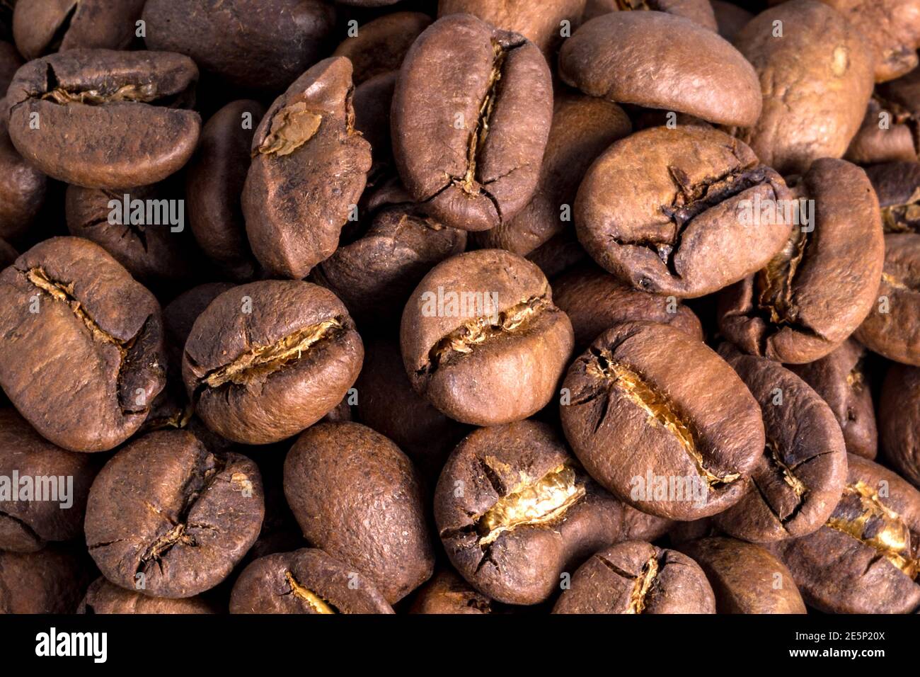 Coffee beans. Brown, roasted seeds. Coffee on a macro scale. Roasted