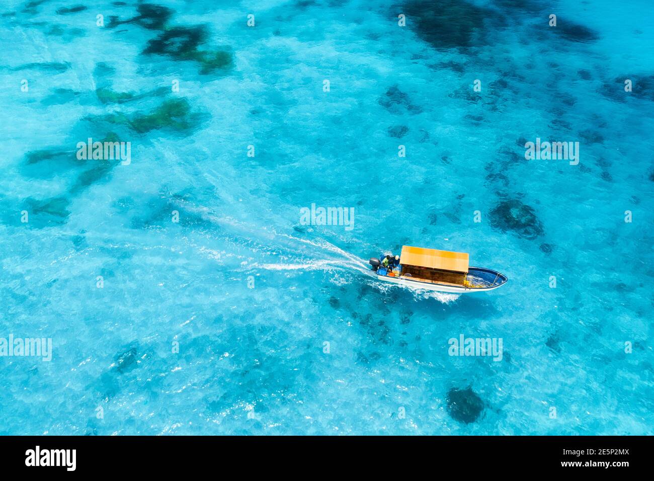 Aerial view of the white boat in the clear blue water at sunset Stock ...