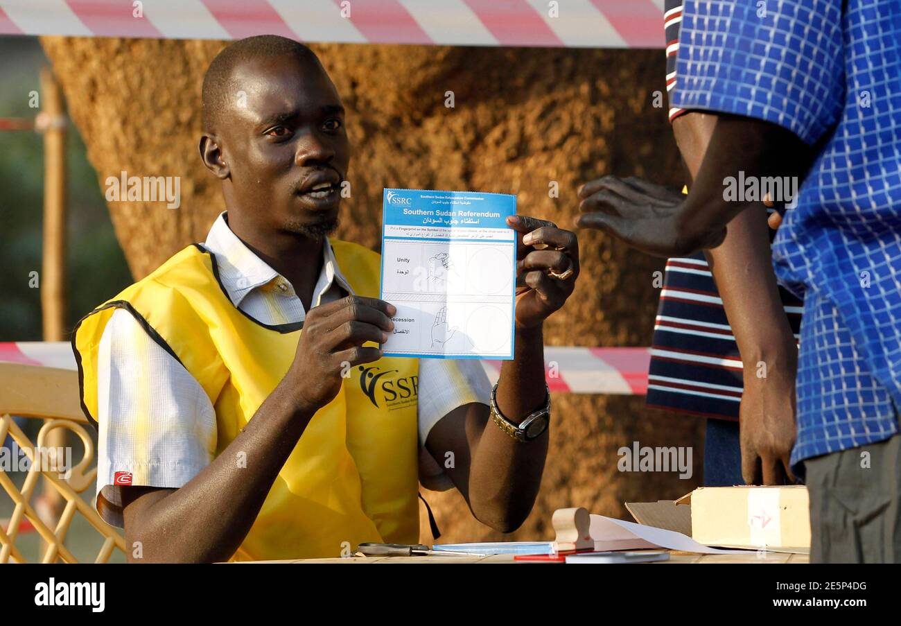 An Electoral Official Attends To A Voter Before He Casts His Ballot For The Referendum In Juba South Sudan January 13 2011 South Sudan Moved A Step Closer To Independence After Organisers