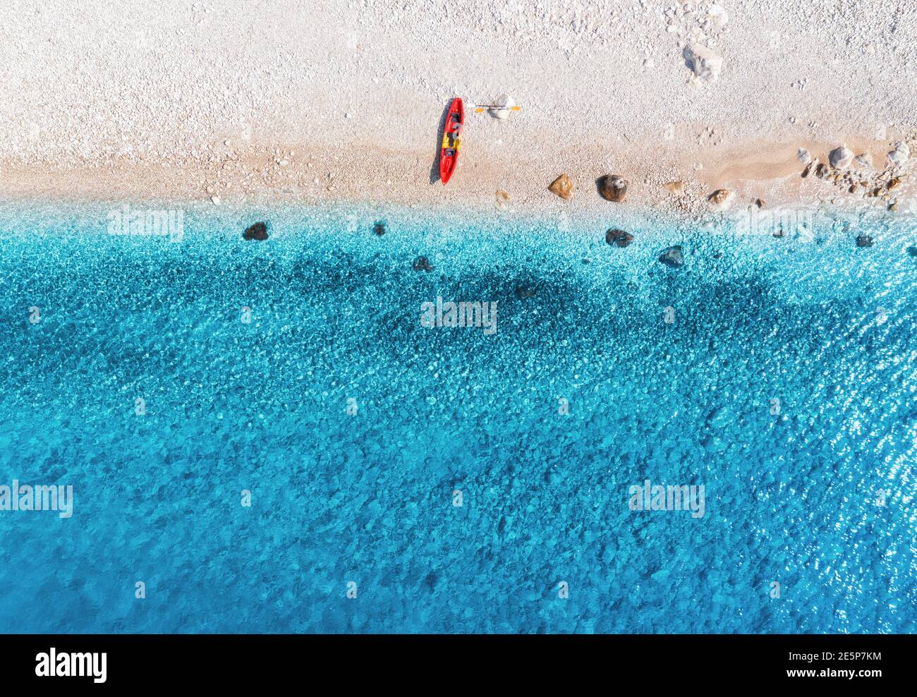 Aerial view of empty sandy beach with red canoe Stock Photo