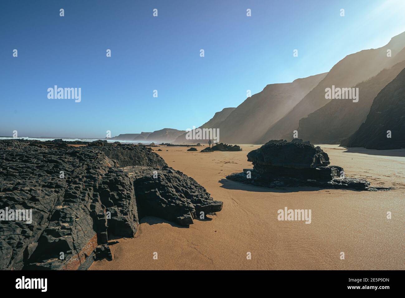 Beautiful landscape from Algarve (Portugal), summer sky with ocean waves, sand and cliff/rocks. Sandy Portuguese beach in the south coast. Stock Photo