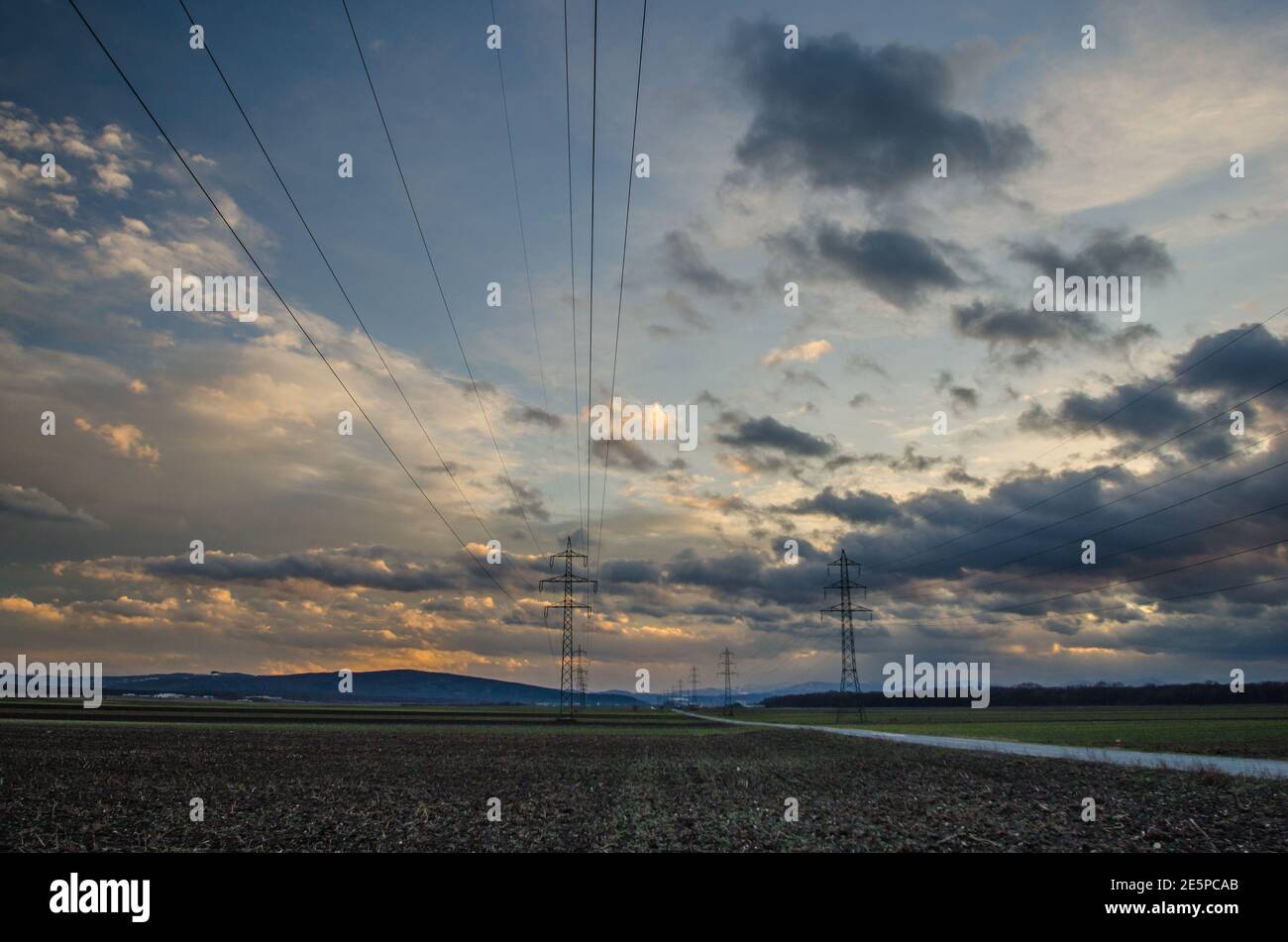 electricity pylons and sky with clouds Stock Photo - Alamy