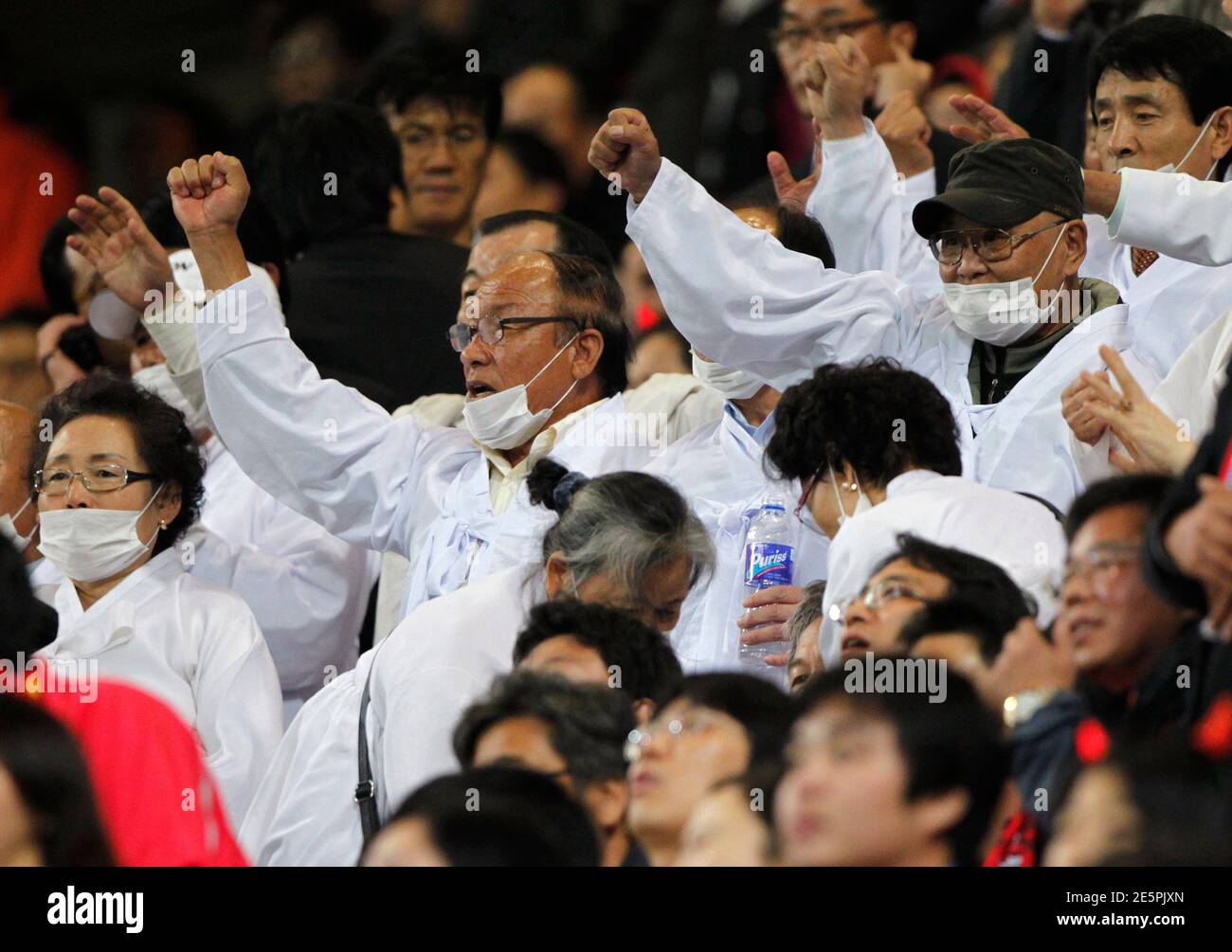 Members (wearing white clothes) of the Association for the Pacific War Victims shout slogans during an anti-Japan rally demanding full compensation from the Japanese government during a friendly soccer match between South Korea and Japan in Seoul October 12, 2010.  REUTERS/Jo Yong-Hak (SOUTH KOREA - Tags: SPORT SOCCER CIVIL UNREST POLITICS) Stock Photo