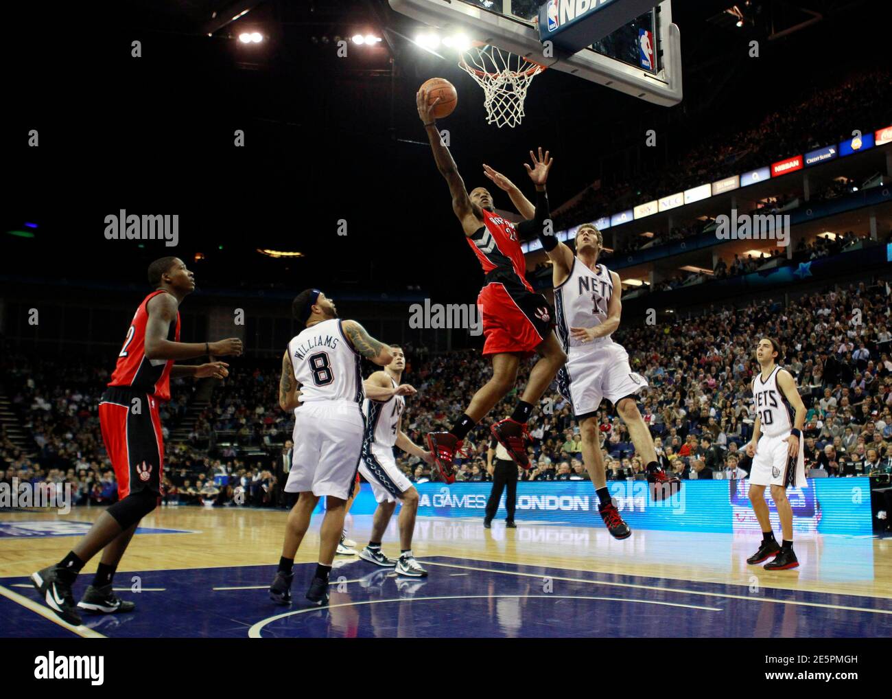 Toronto Raptors forward Sonny Weems (C) scores a basket against New Jersey  Nets in the second quarter of their NBA basketball game in London March 4,  2011. REUTERS/Eddie Keogh (BRITAIN - Tags: