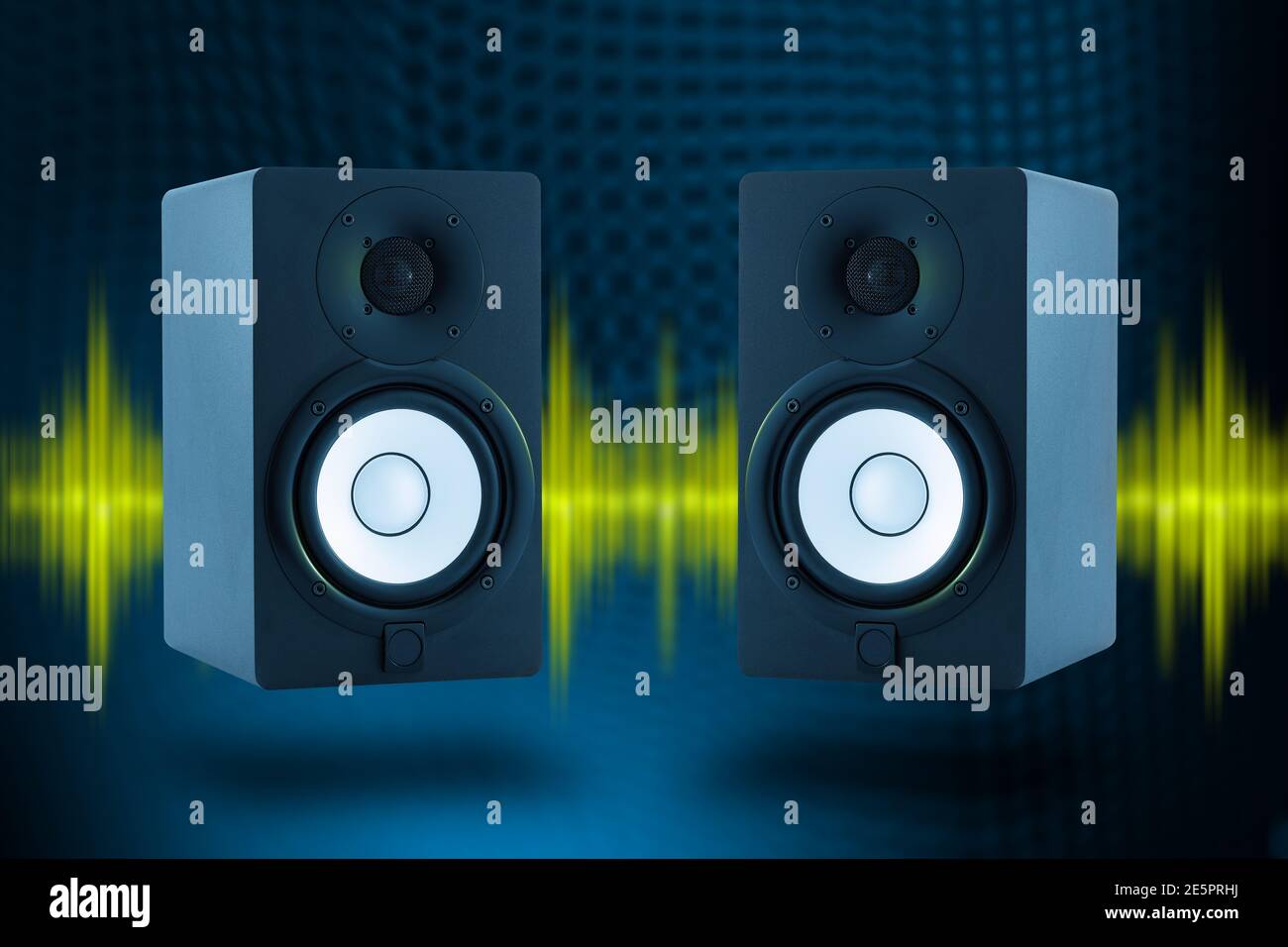 Pair of professional high quality monitor speakers with yellow sound waves and deep blue background. Music and Radio concept. Stock Photo