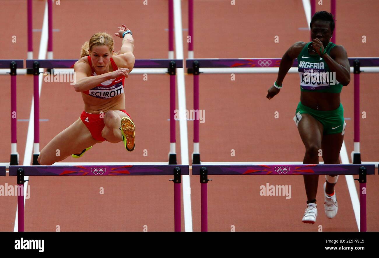 Austria's Beate Schrott (L) competes with Nigeria's Seun Adigun in their  round 1 women's 100m hurdles heat during the London 2012 Olympic Games at  the Olympic Stadium August 6, 2012. REUTERS/David Gray (