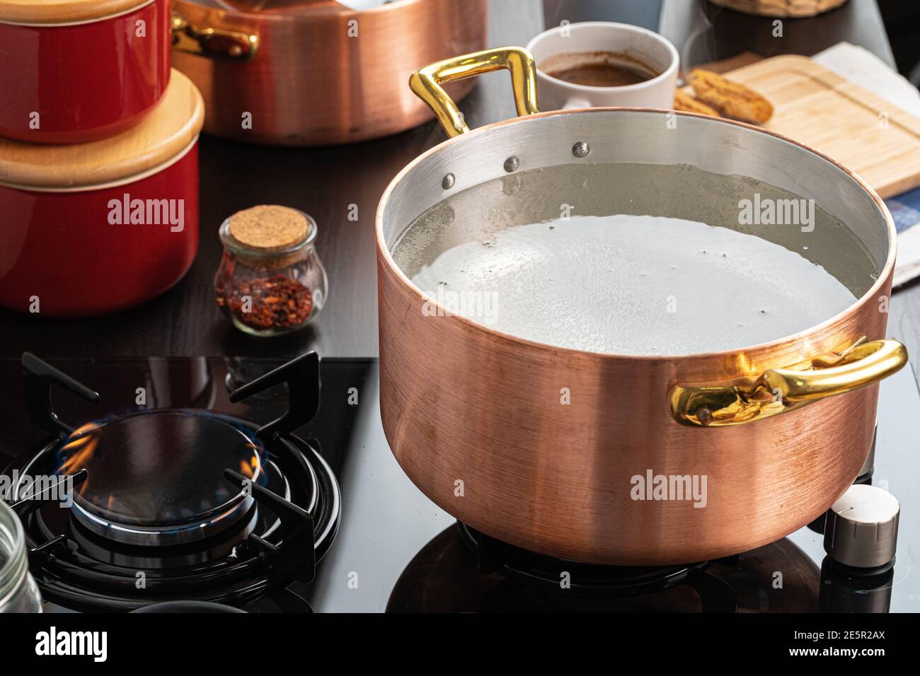 Copper pot with boiling water on a gas stove Stock Photo Alamy